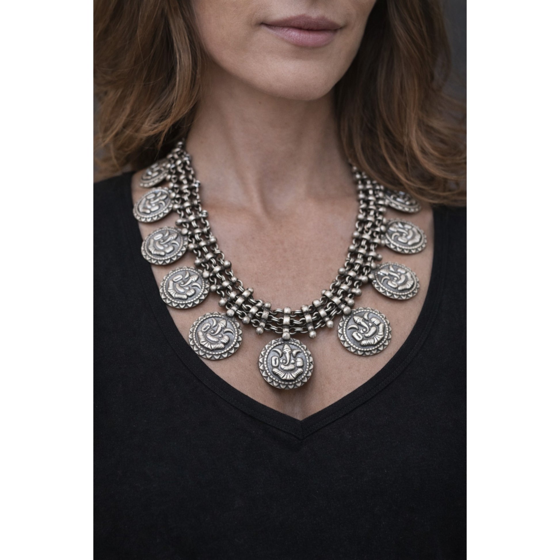 SILVER NECKLACE WITH LAYERED CHAIN DESIGN AND ENGRAVED COIN SHAPE GANESH