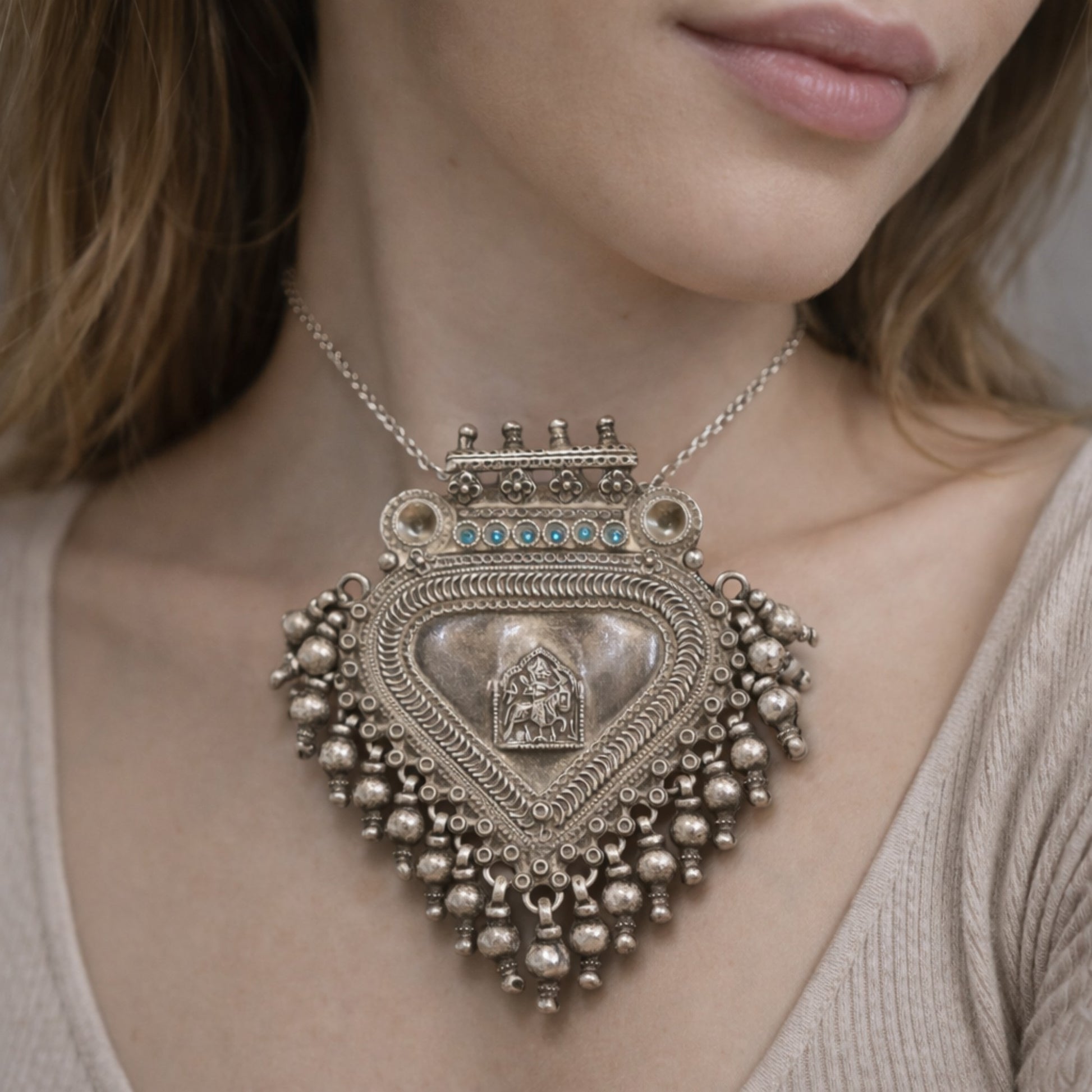SILVER PENDANT WITH TRIBAL MOTIF , BLUE ACCENTS , AND HANGING BEEDS