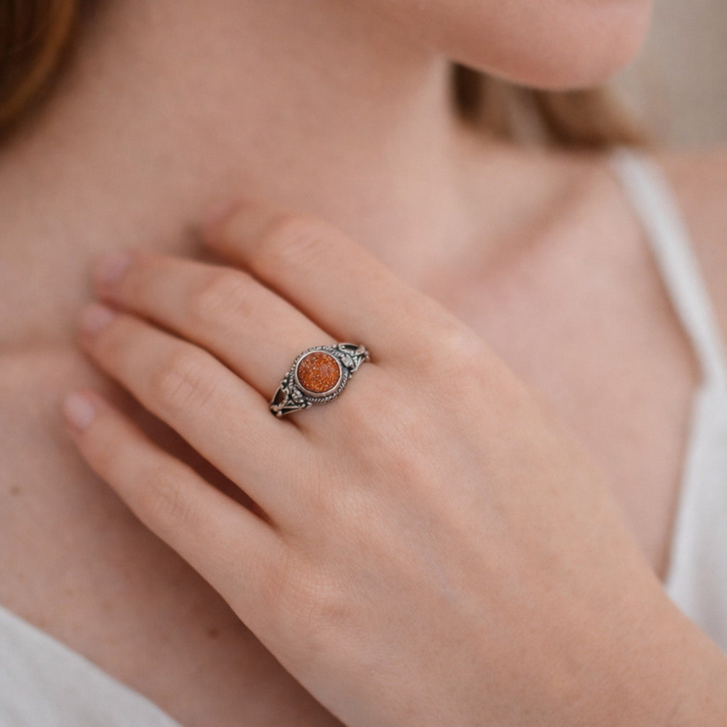SILVER RING STUDDED WITH SUNSTONE