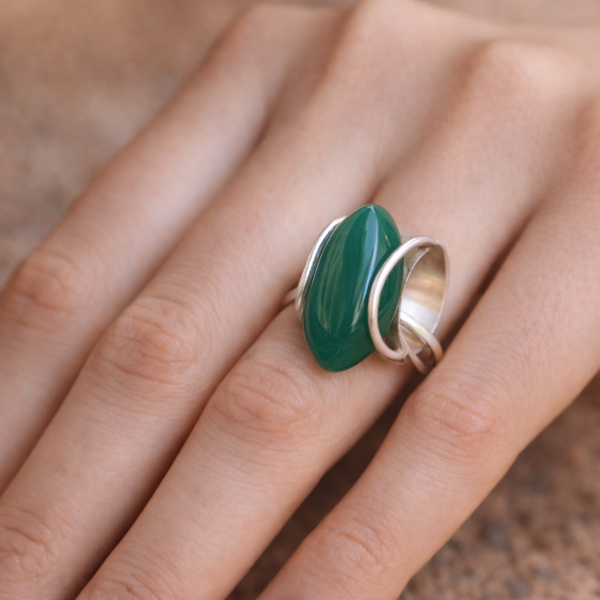 SILVER RING WITH LARGE GREEN ONYX IN A WRAP DESIGN