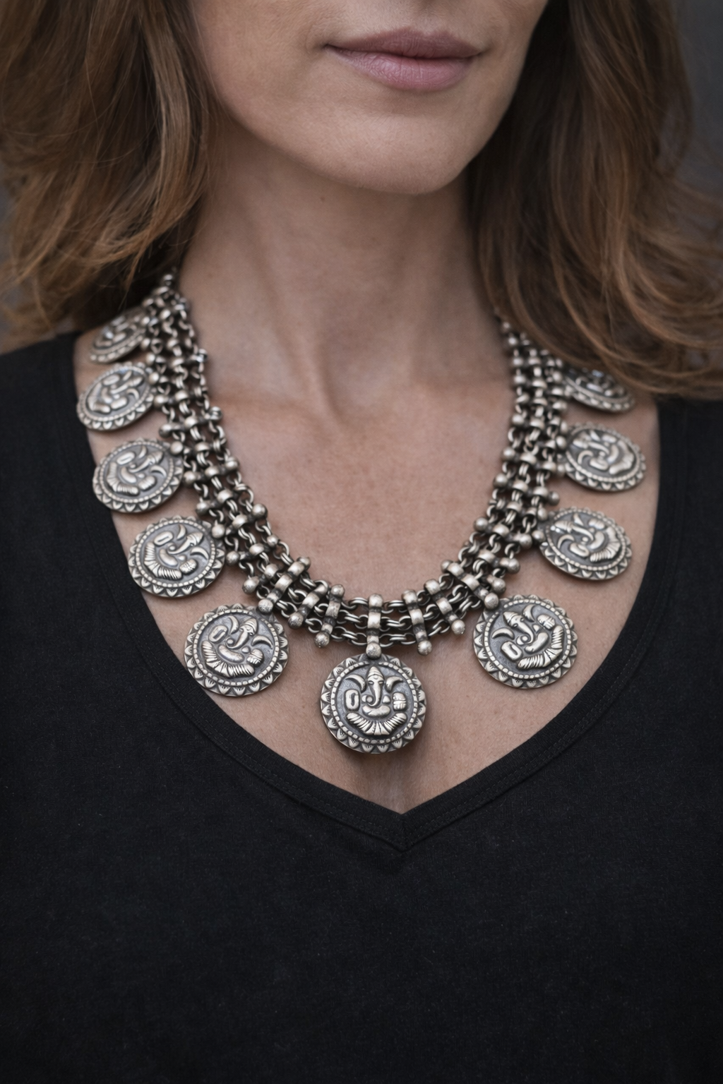 SILVER NECKLACE WITH LAYERED CHAIN DESIGN AND ENGRAVED COIN SHAPE GANESH