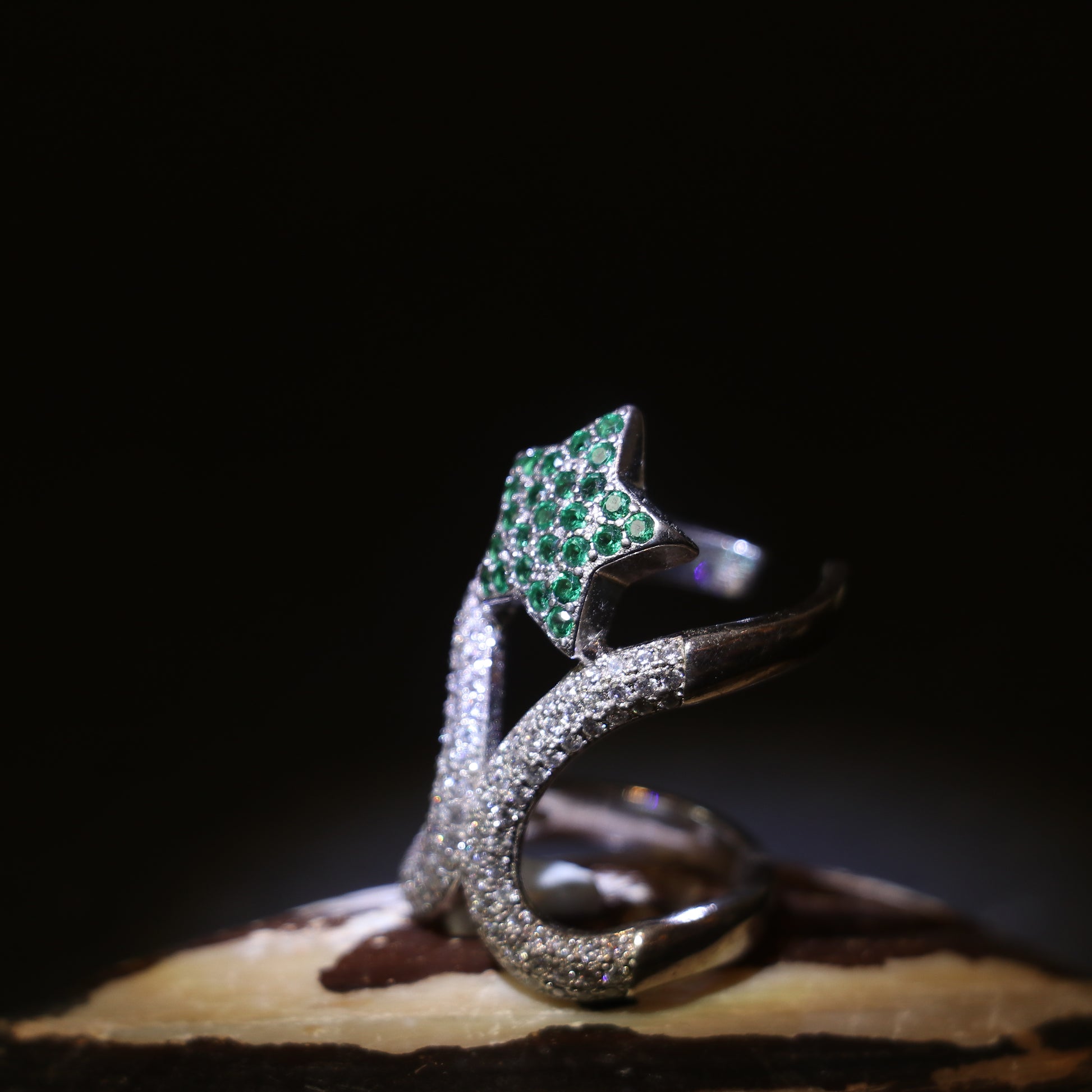 SILVER RING WITH ZIRCON STUDDED CURVES AND A GREEN GEMSTONE
