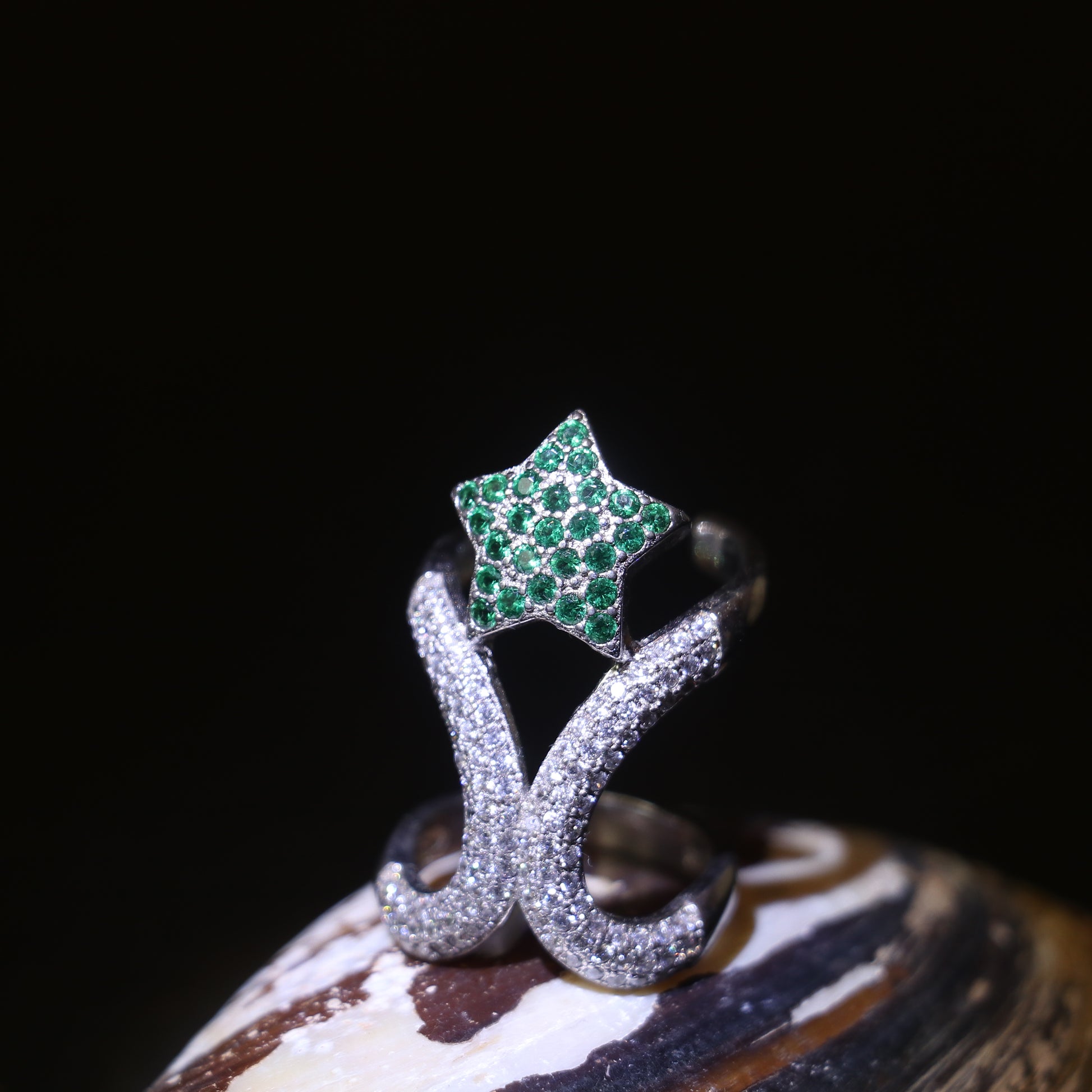 SILVER RING WITH ZIRCON STUDDED CURVES AND A GREEN GEMSTONE