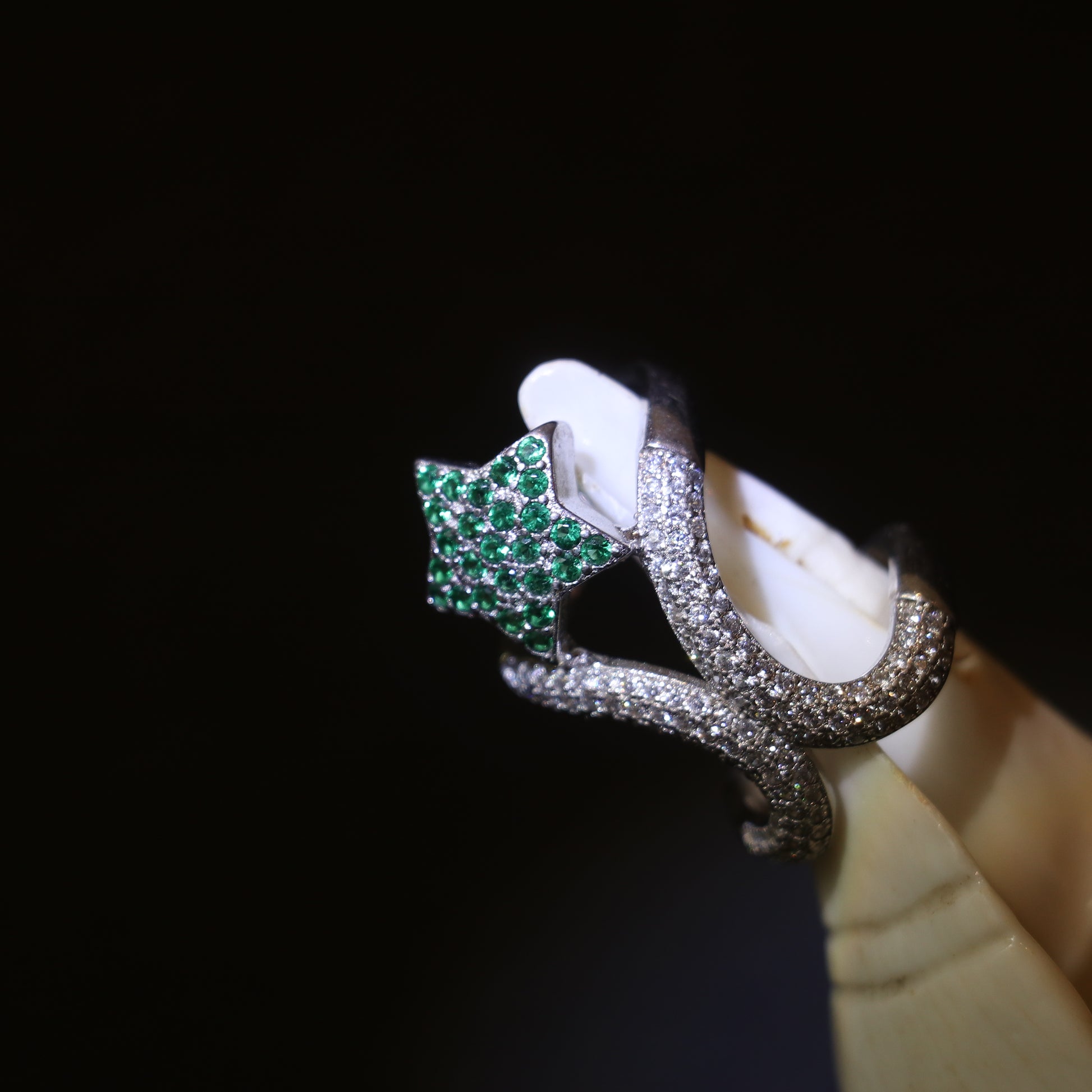 SILVER RING WITH ZIRCON STUDDED CURVES AND A GREEN GEMSTONE
