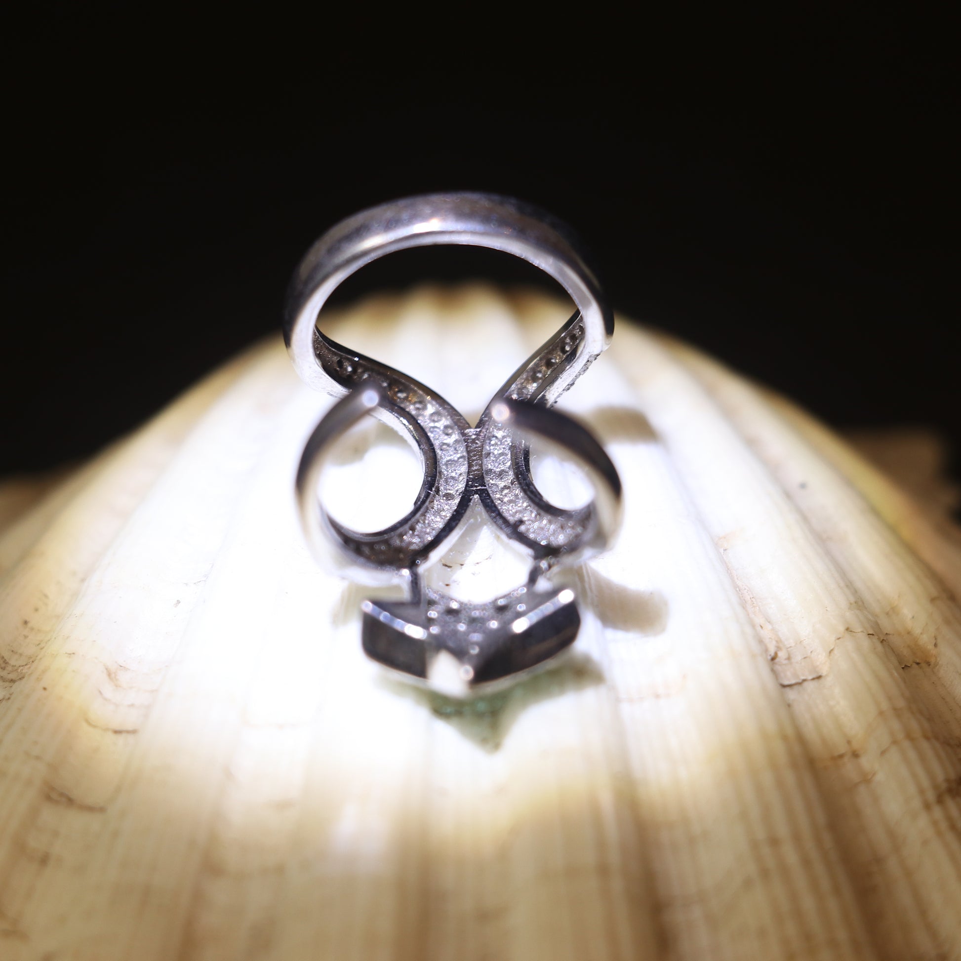 SILVER RING WITH ZIRCON STUDDED CURVES AND A GREEN GEMSTONE