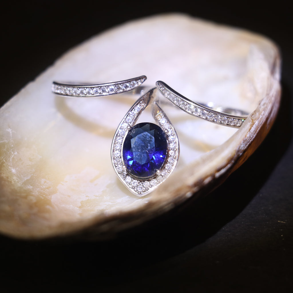 SILVER RING WITH TEARDROP HALO AND BLUE STONE