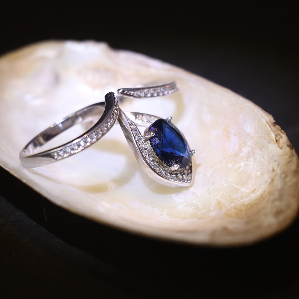 SILVER RING WITH TEARDROP HALO AND BLUE STONE