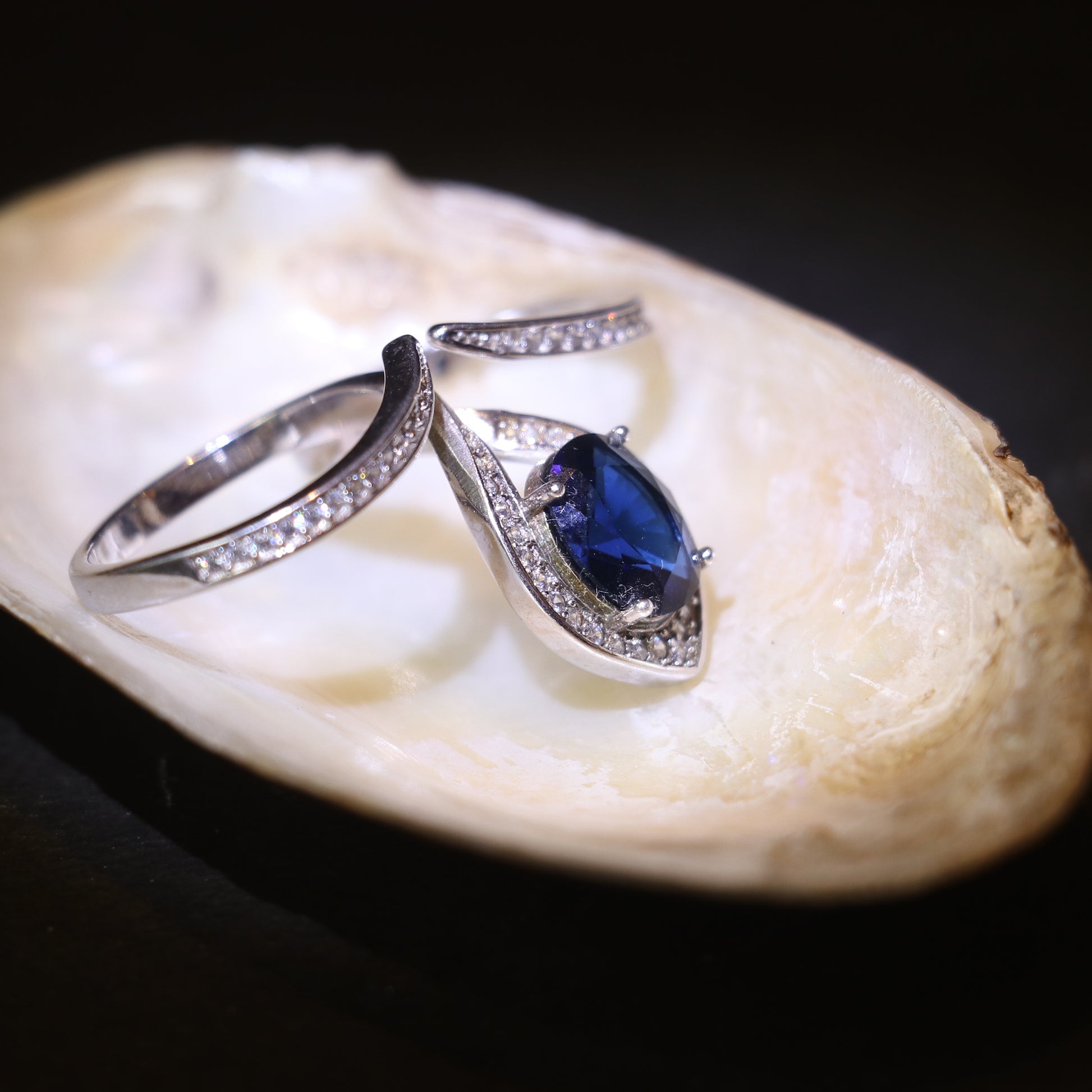 SILVER RING WITH TEARDROP HALO AND BLUE STONE