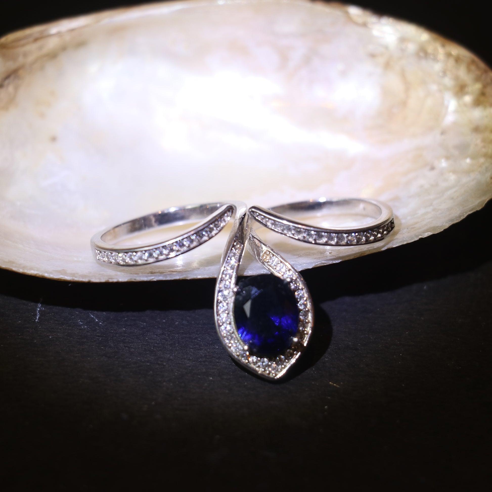 SILVER RING WITH TEARDROP HALO AND BLUE STONE