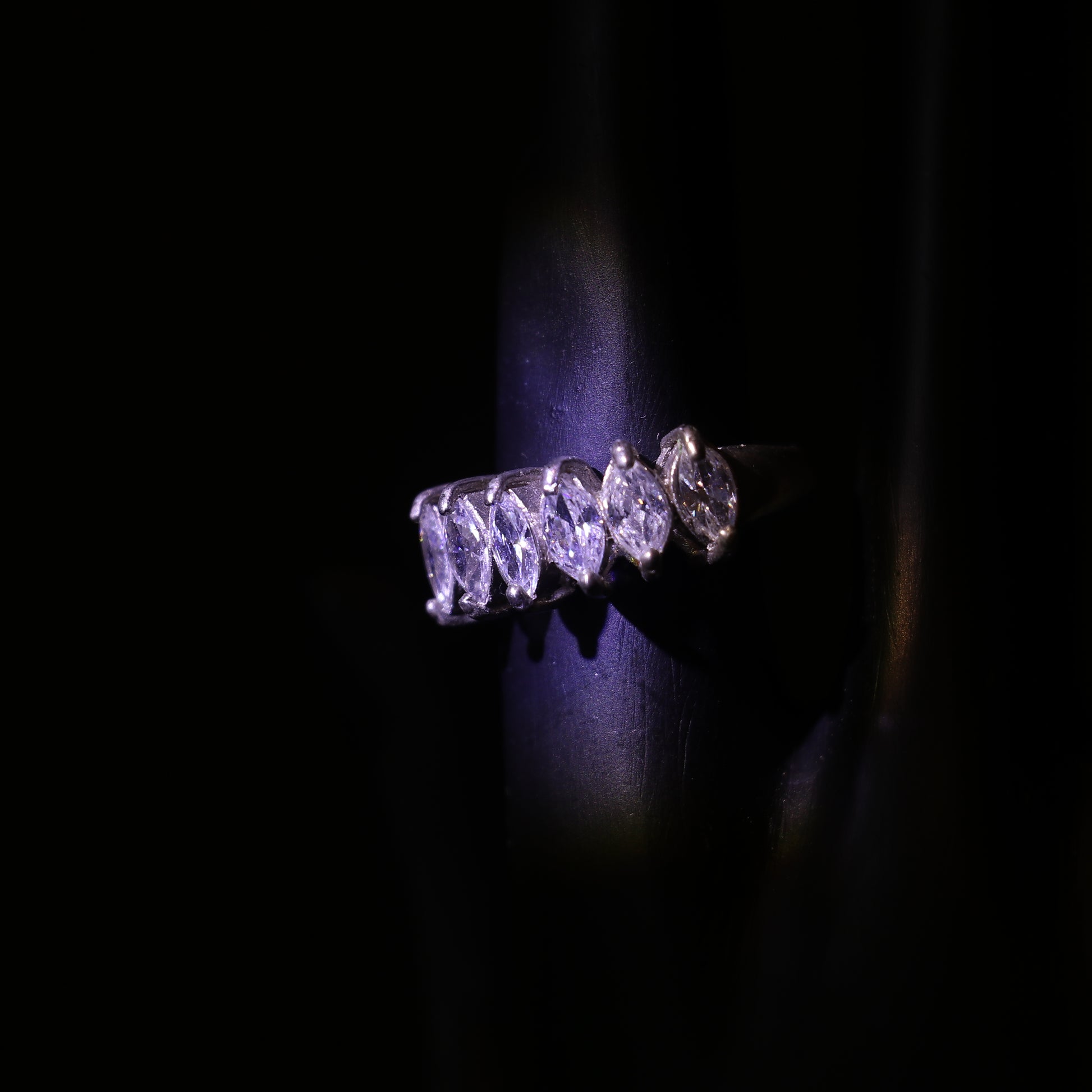SILVER RING WITH A ROW OF MARQUISE CUT ZIRCONS