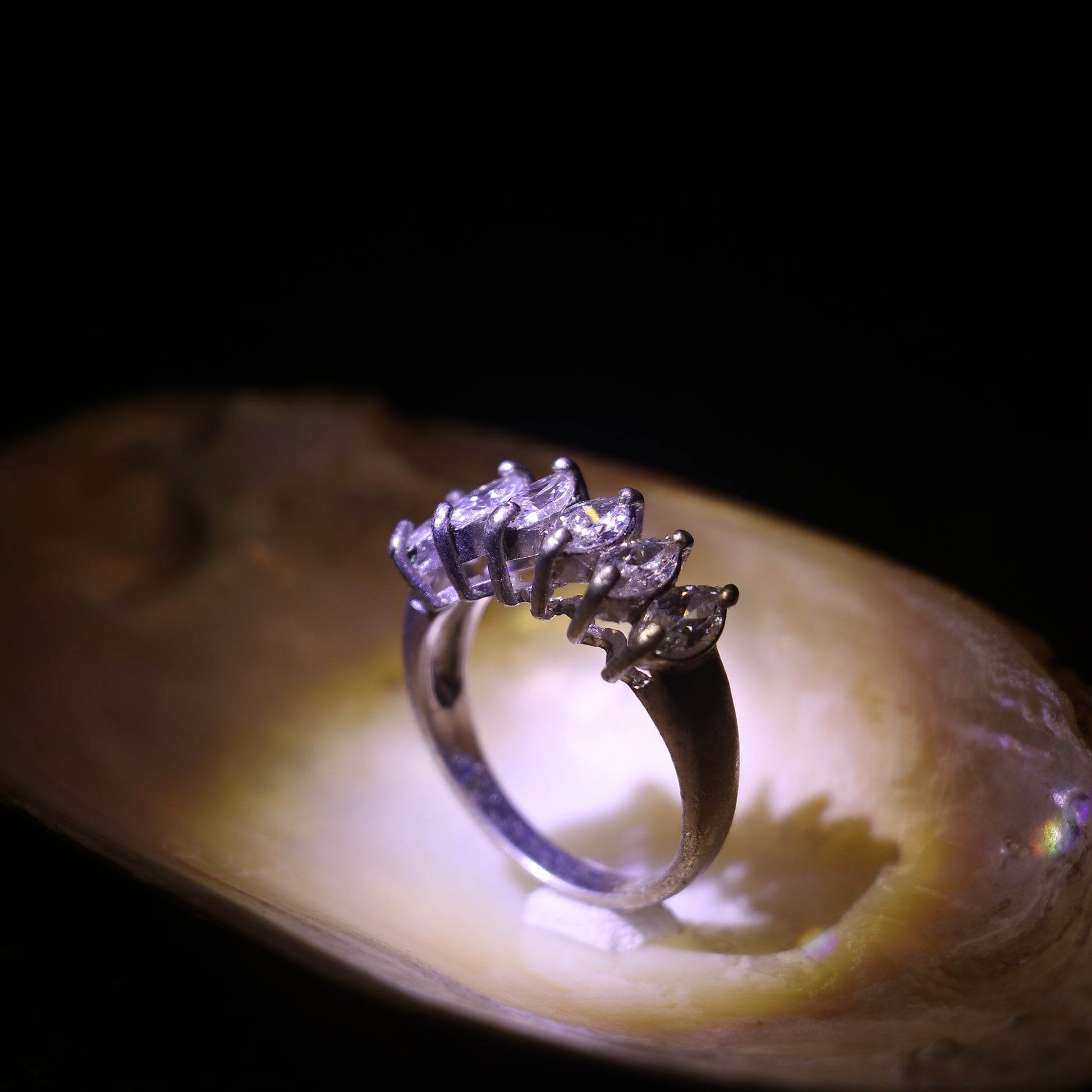 SILVER RING WITH A ROW OF MARQUISE CUT ZIRCONS