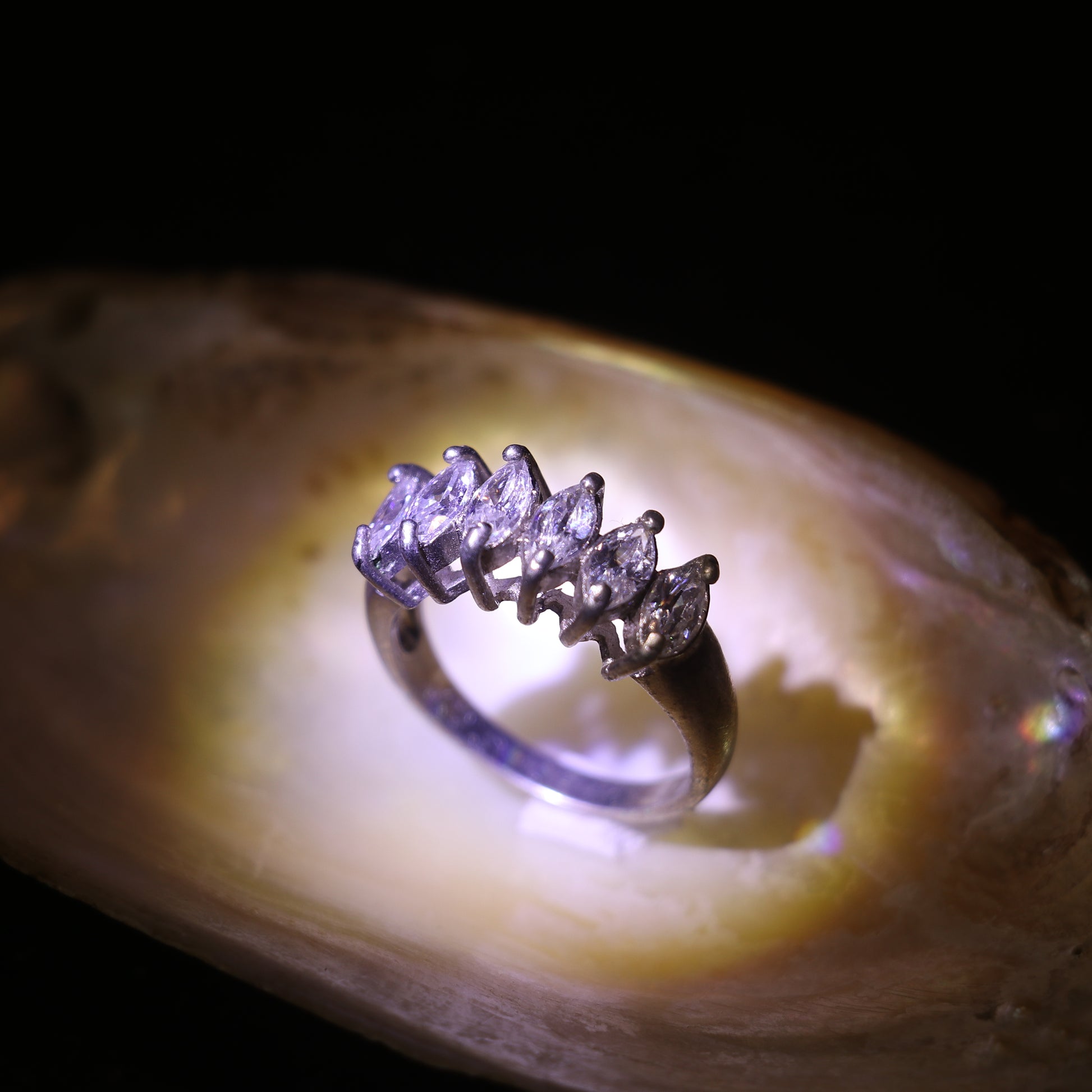 SILVER RING WITH A ROW OF MARQUISE CUT ZIRCONS