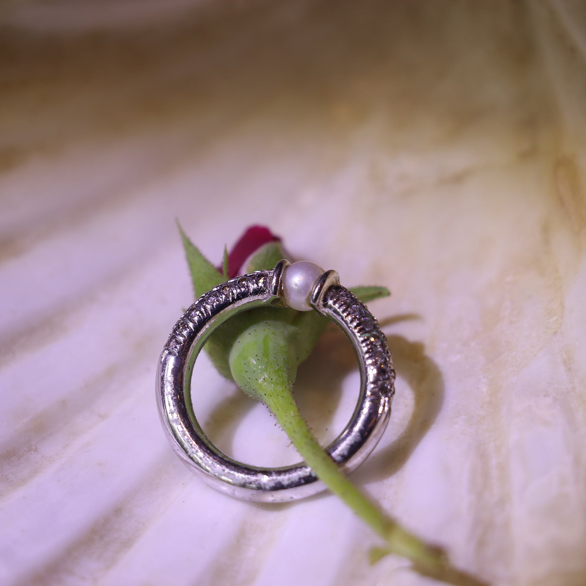 SILVER RING WITH A PEARL CENTER AND A ZIRCON STUDDED BAND