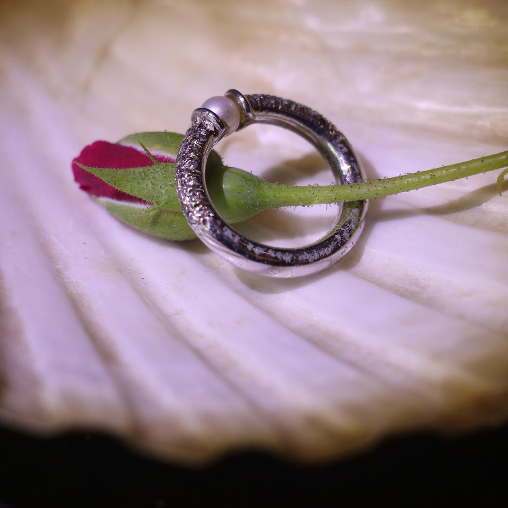 SILVER RING WITH A PEARL CENTER AND A ZIRCON STUDDED BAND