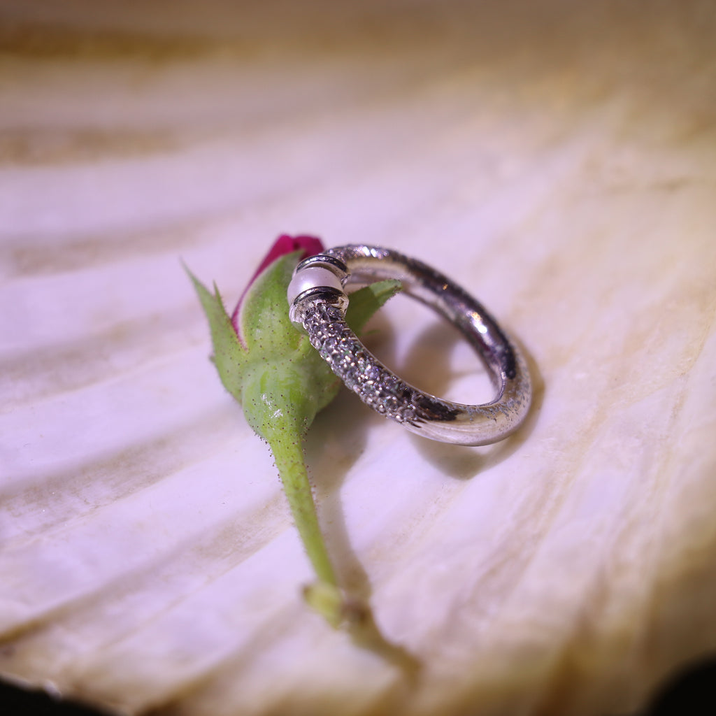 SILVER RING WITH A PEARL CENTER AND A ZIRCON STUDDED BAND