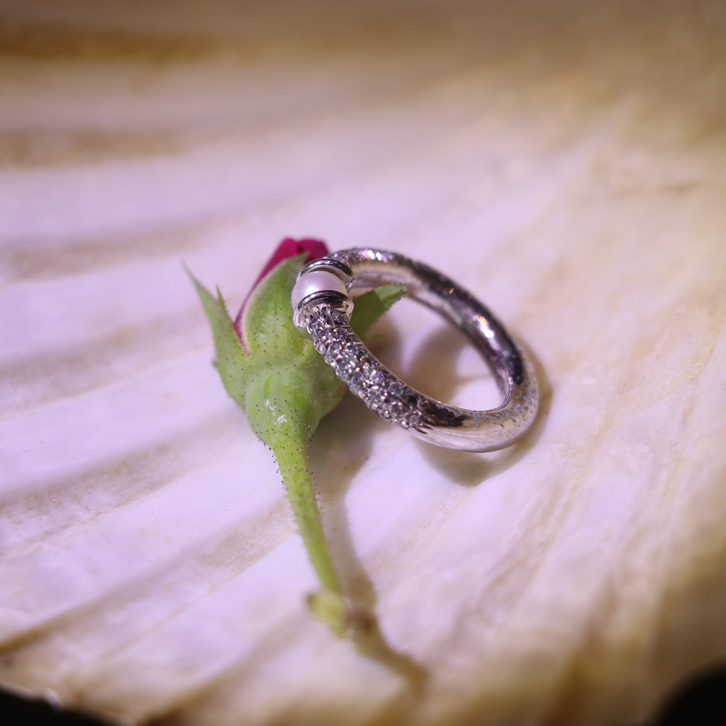 SILVER RING WITH A PEARL CENTER AND A ZIRCON STUDDED BAND