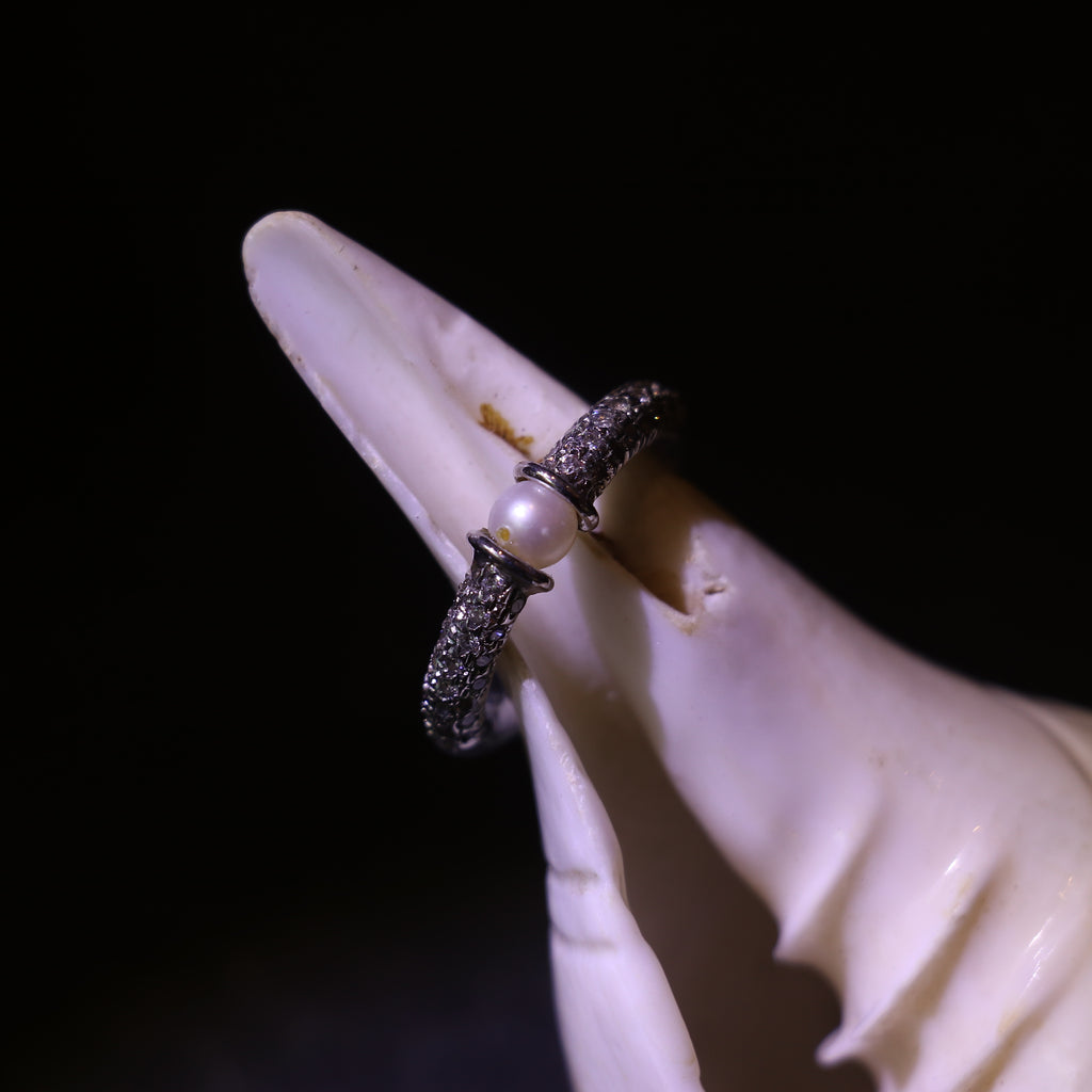 SILVER RING WITH A PEARL CENTER AND A ZIRCON STUDDED BAND