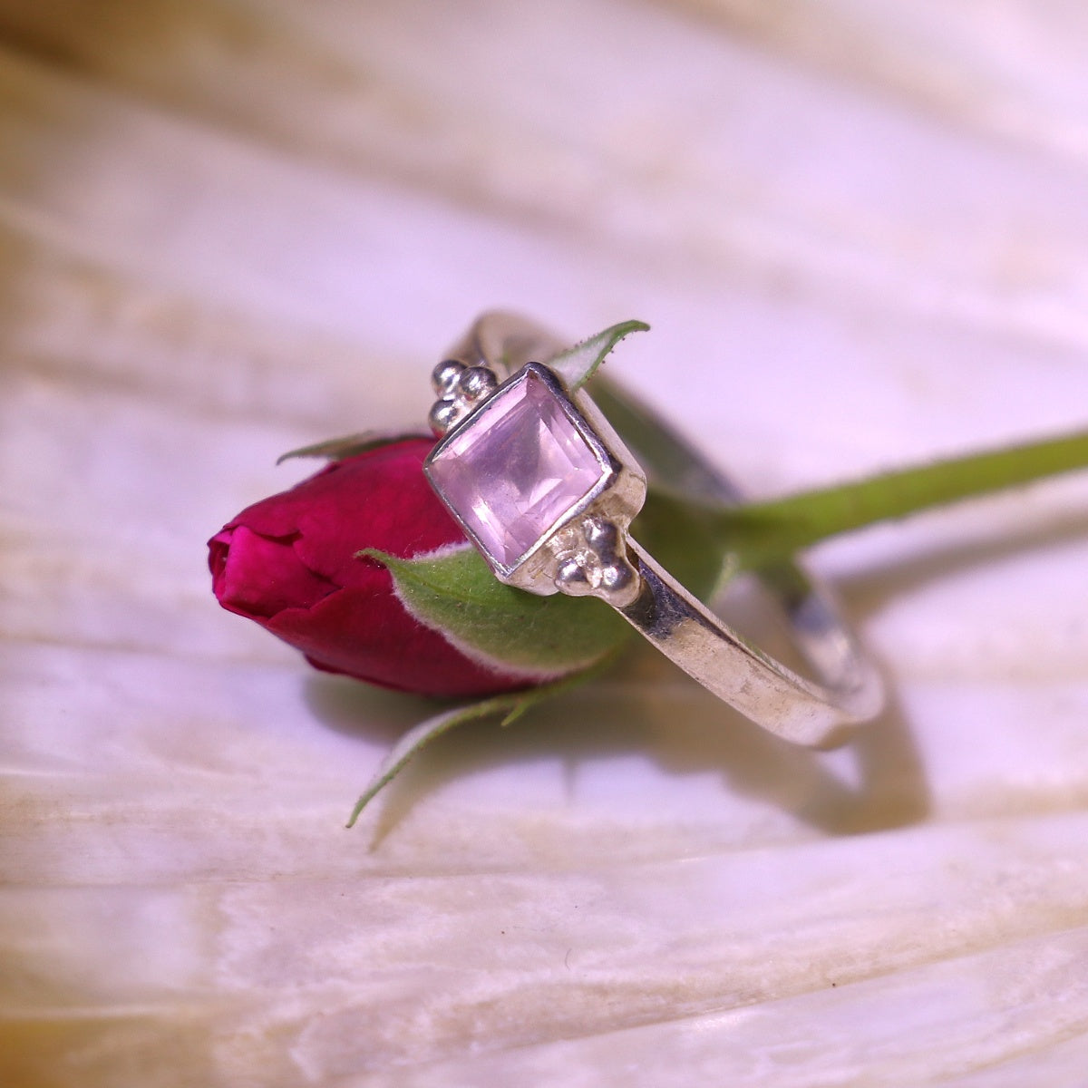 Silver ring adorned with a bold square-cut pink gemstone