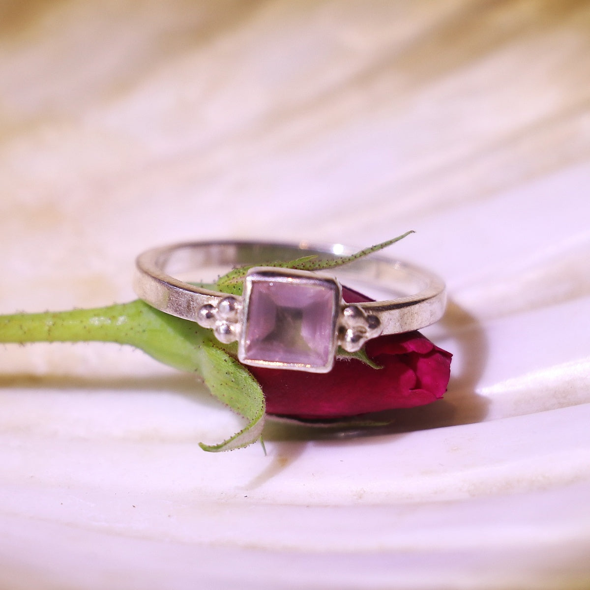 Silver ring adorned with a bold square-cut pink gemstone