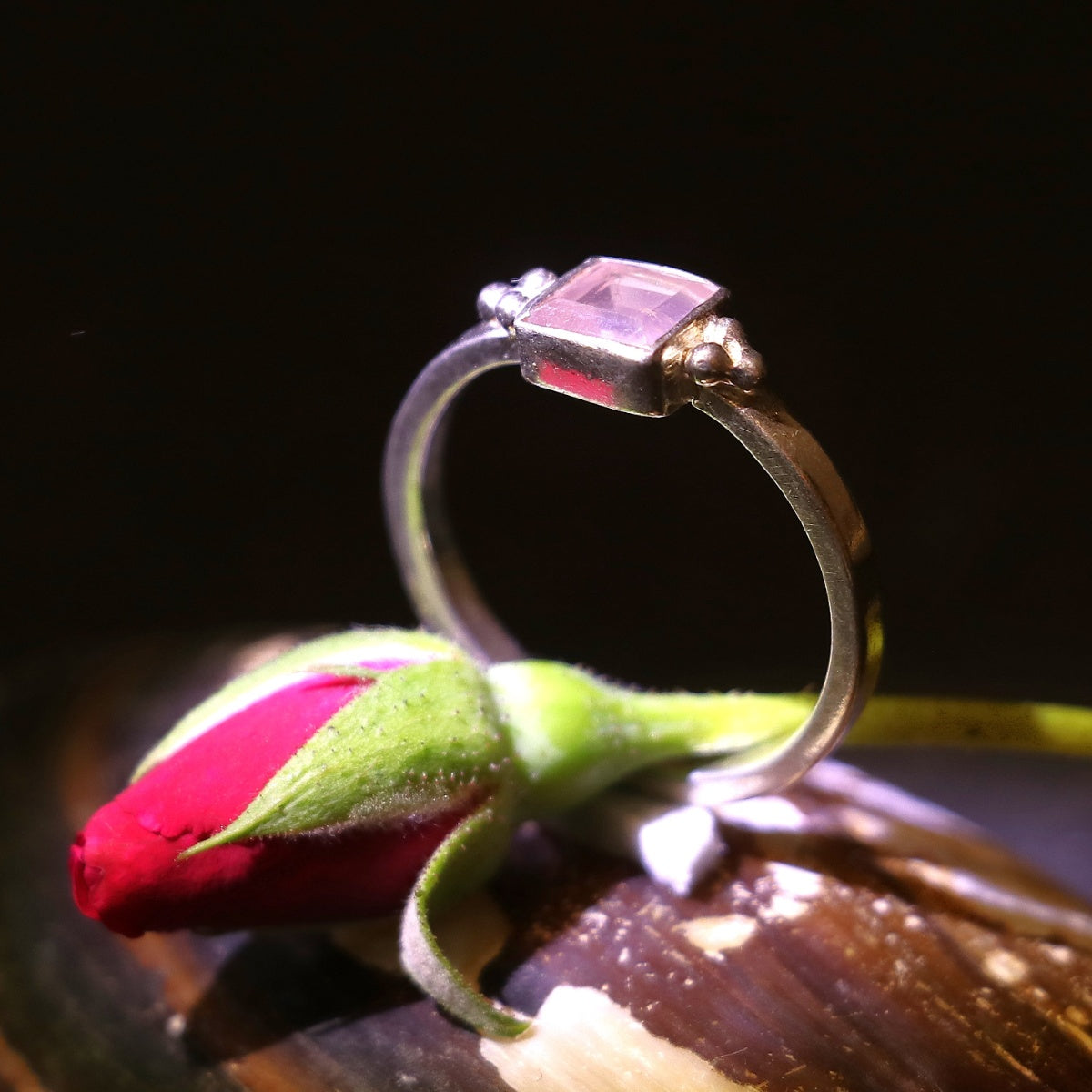 Silver ring adorned with a bold square-cut pink gemstone