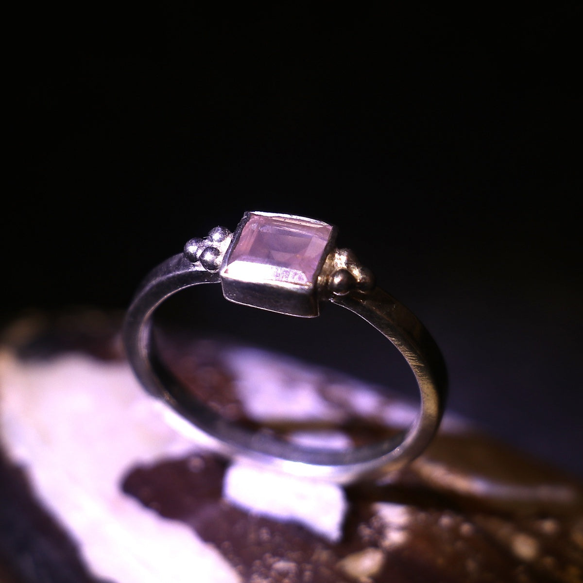 Silver ring adorned with a bold square-cut pink gemstone
