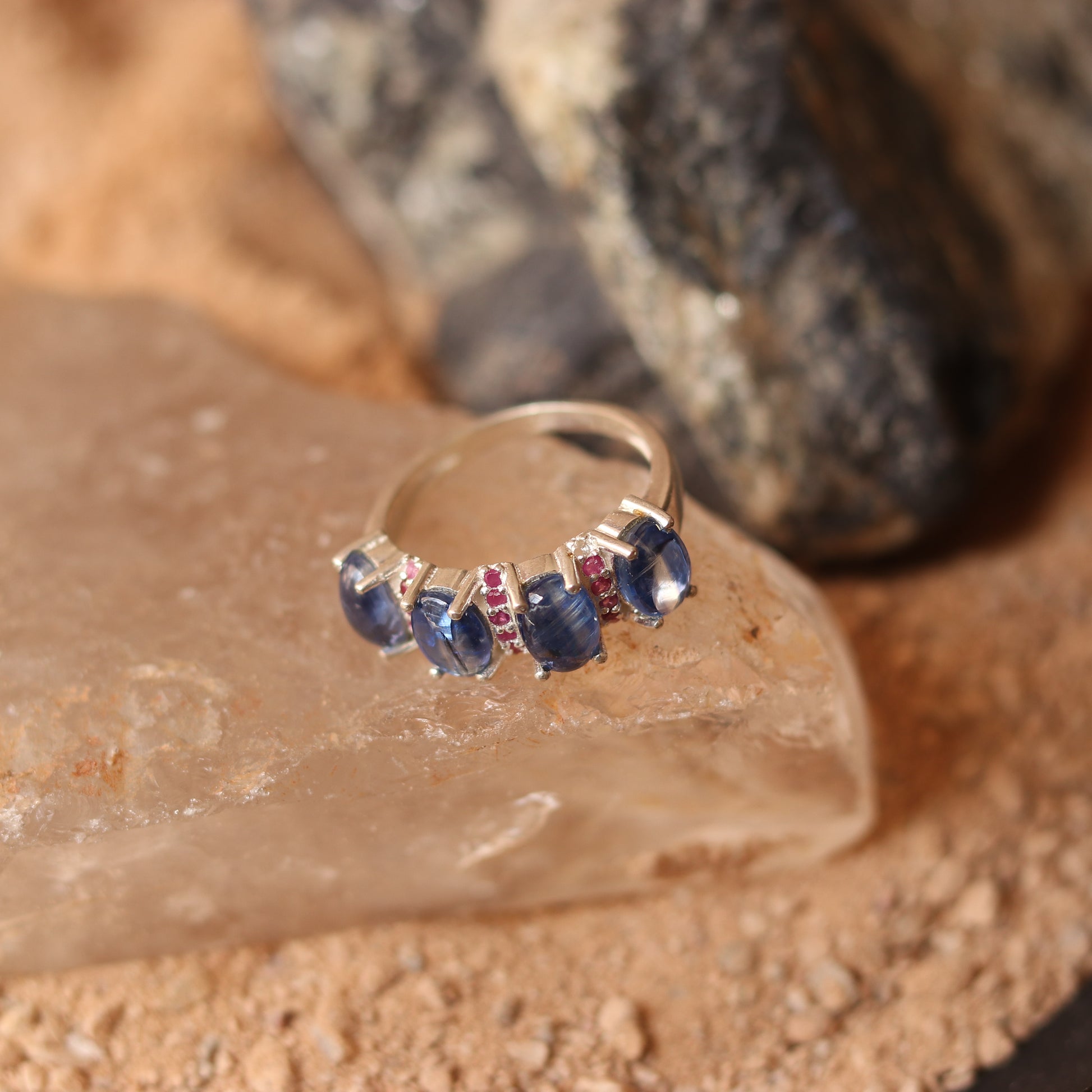 SILVER RING STUDDED WITH RUBIES AND TANZANITE