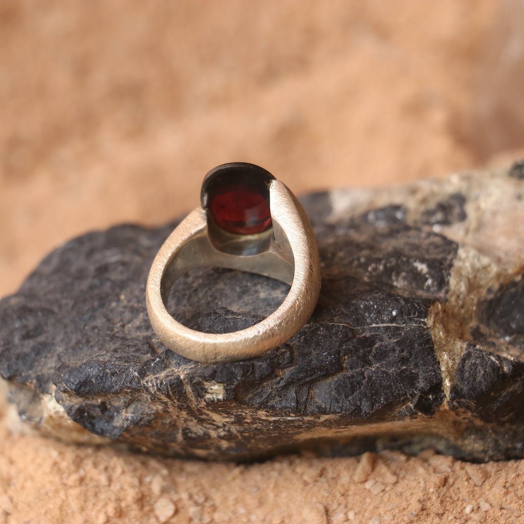 SILVER SMOOTH BAND FEATURING A GARNET