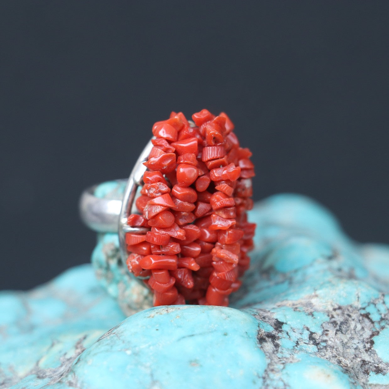 CHUNKY SILVER RING ADORNED WITH A CLUSTERED RED CORAL BEEDS