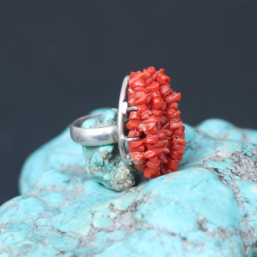 Chunky silver ring adorned with a clustered red coral beads