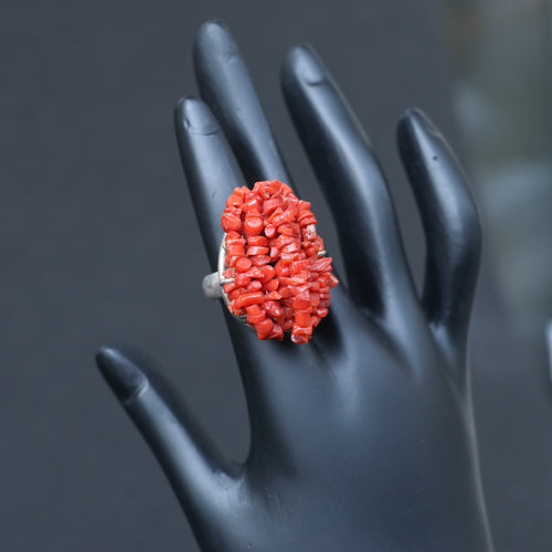 Chunky silver ring adorned with a clustered red coral beads