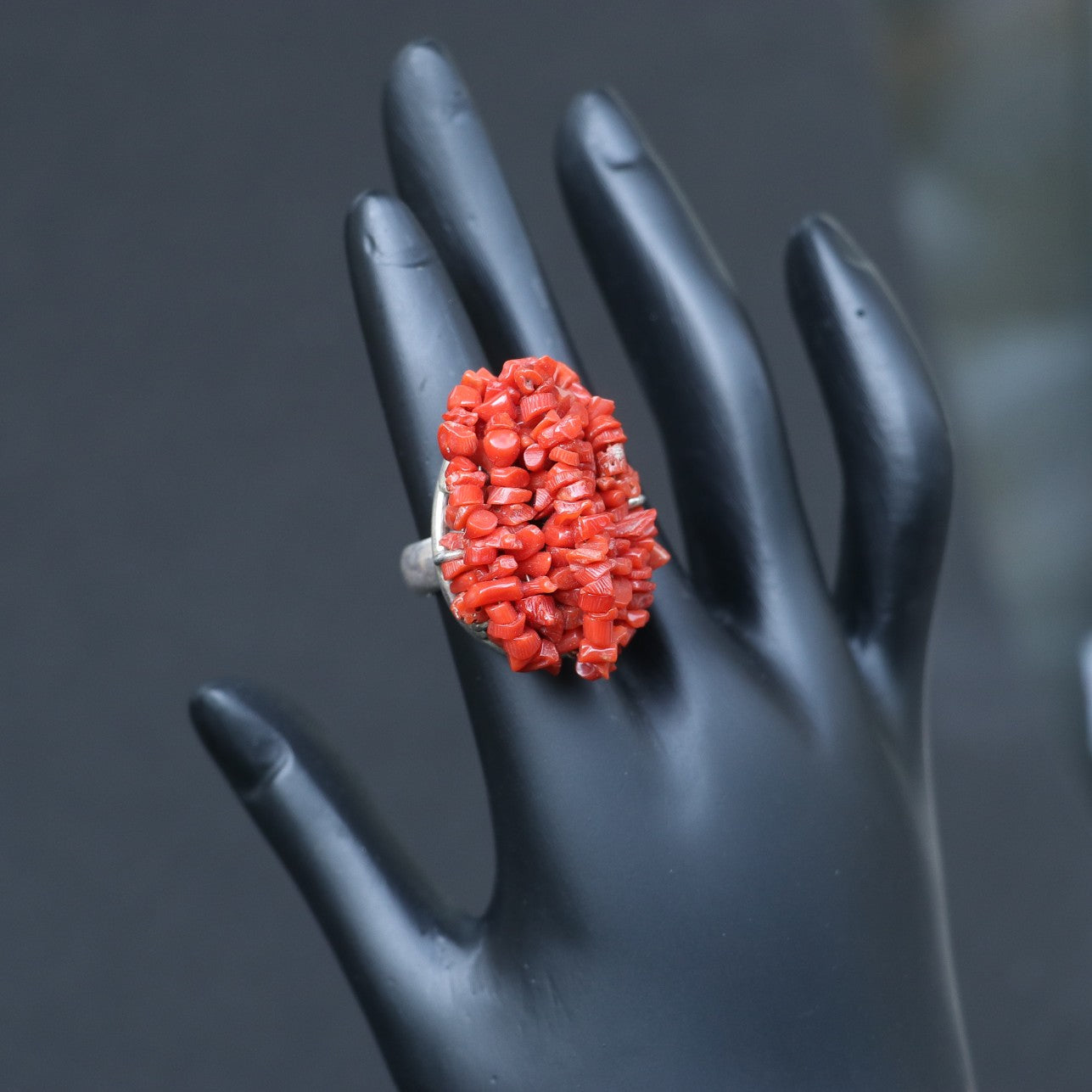 CHUNKY SILVER RING ADORNED WITH A CLUSTERED RED CORAL BEEDS