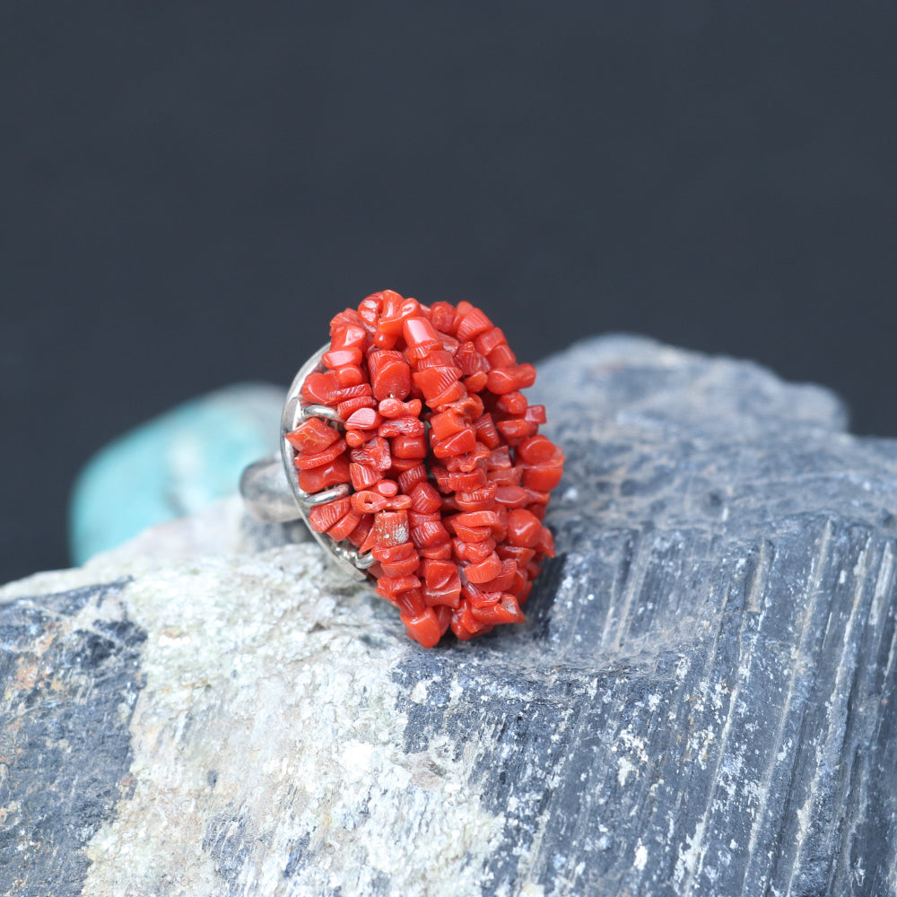 Chunky silver ring adorned with a clustered red coral beads