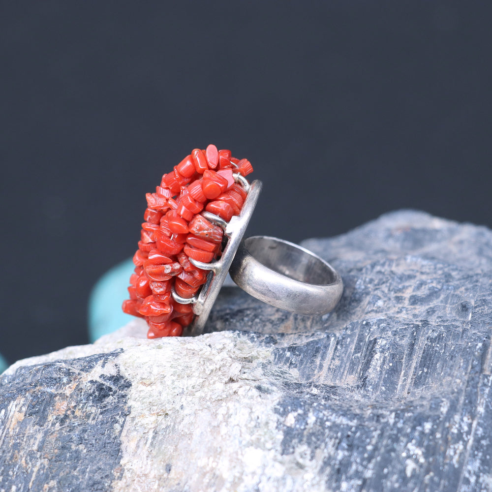 Chunky silver ring adorned with a clustered red coral beads