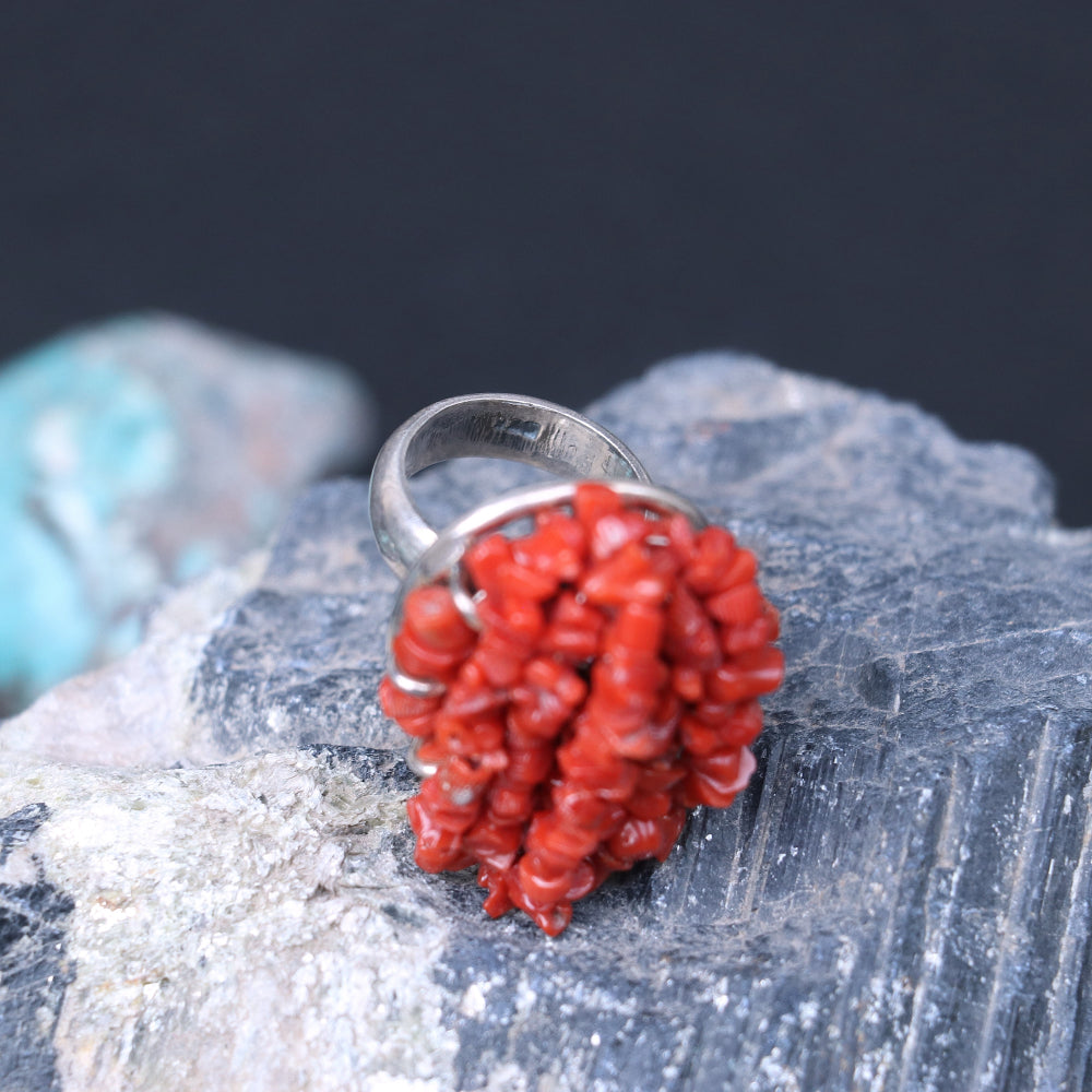 Chunky silver ring adorned with a clustered red coral beads