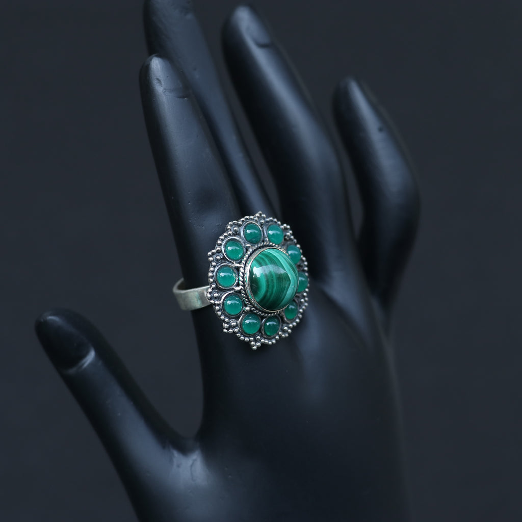 SILVER RING WITH A ROUND MALACHITE STONE WITH SMALL ONYX GREEN STONES