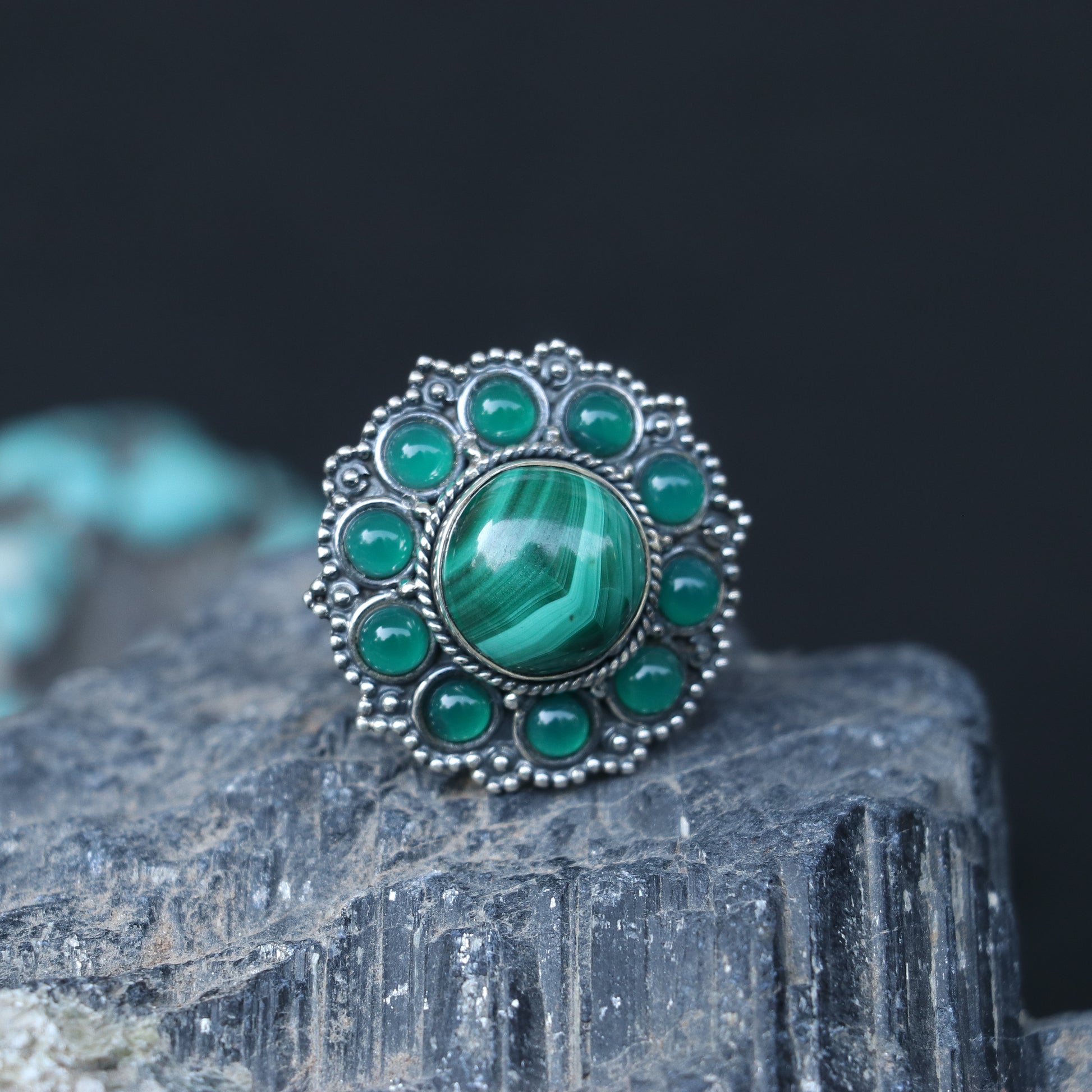 SILVER RING WITH A ROUND MALACHITE STONE WITH SMALL ONYX GREEN STONES