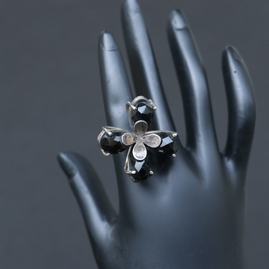 SILVER RING FEATURING SMOKY TOPAZ STONES ARRANGED IN A FLORAL PATTERN
