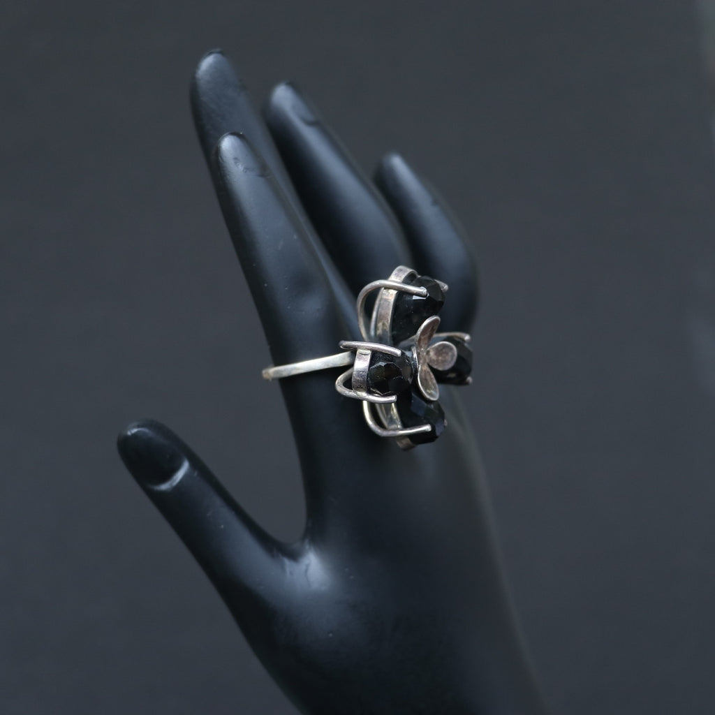SILVER RING FEATURING SMOKY TOPAZ STONES ARRANGED IN A FLORAL PATTERN