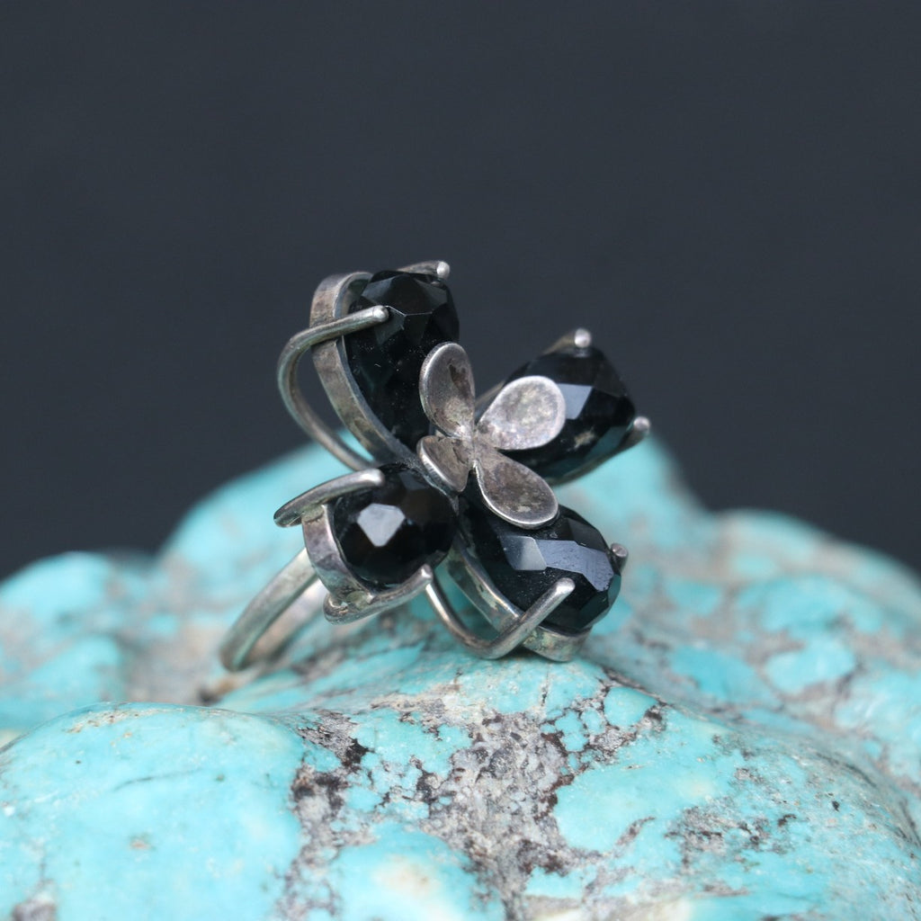 SILVER RING FEATURING SMOKY TOPAZ STONES ARRANGED IN A FLORAL PATTERN
