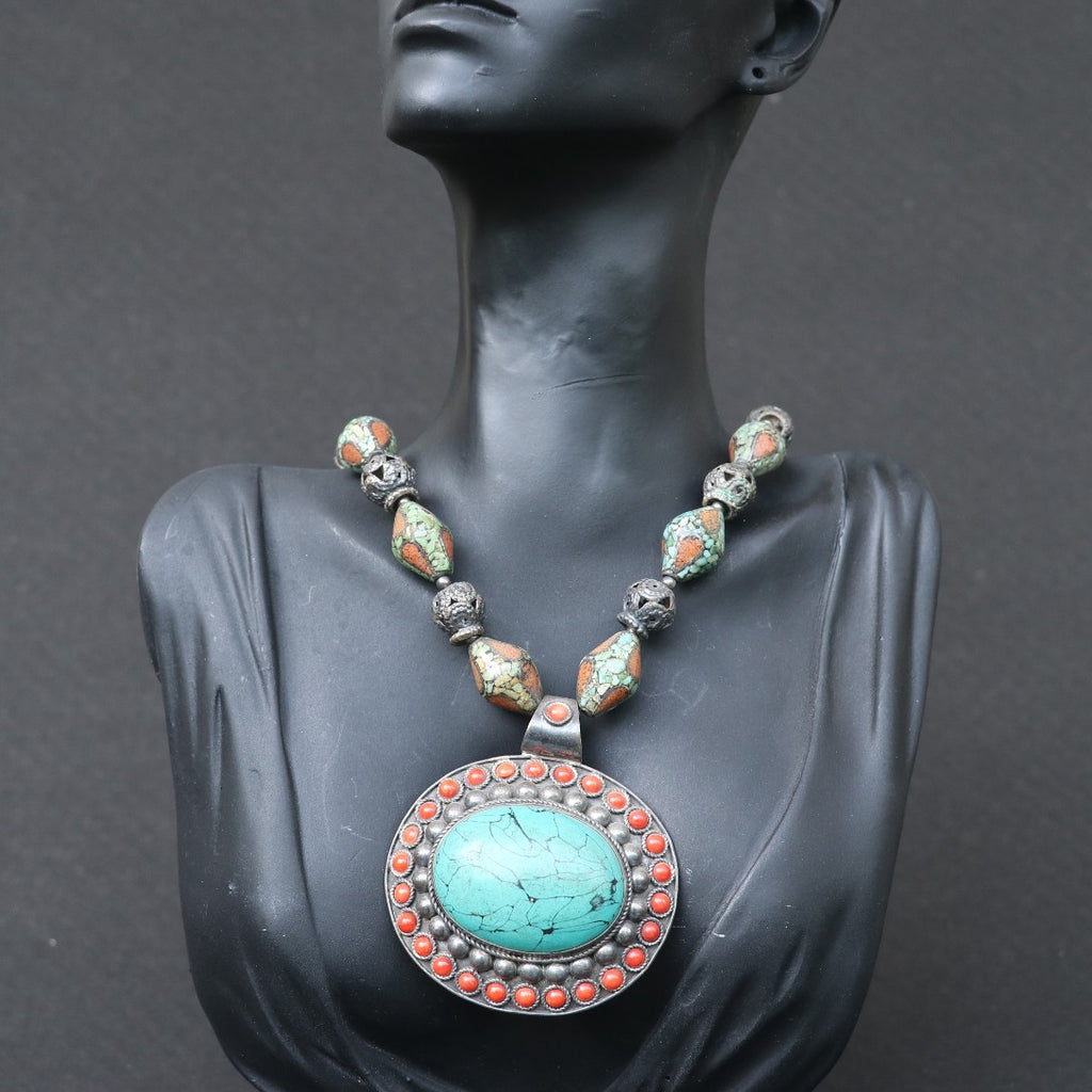TRIBAL NECKLACE WITH TURQUOISE AND CORAL BEEDS , FEATURING A LARGE TURQUOISE PENDANT