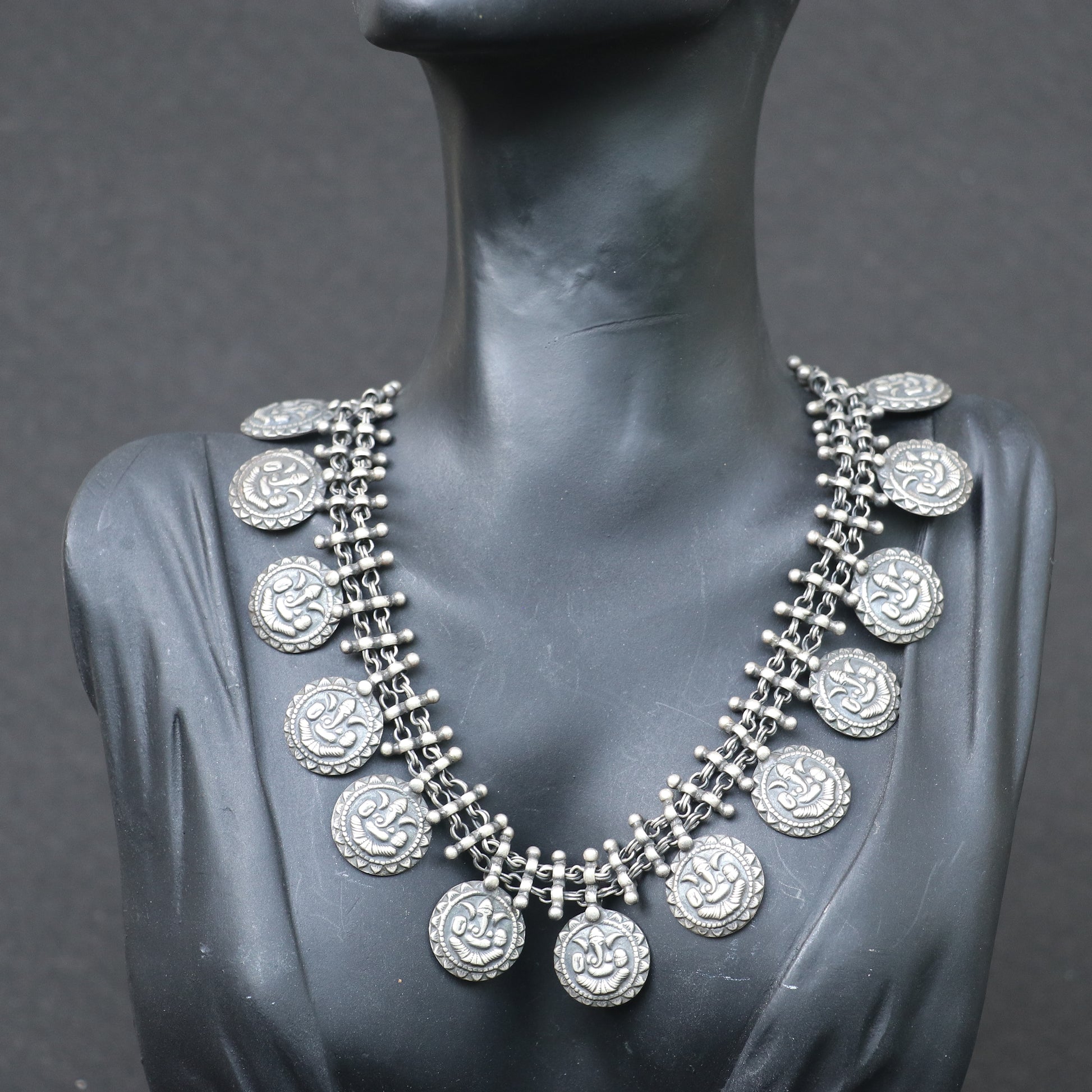 SILVER NECKLACE WITH LAYERED CHAIN DESIGN AND ENGRAVED COIN SHAPE GANESH