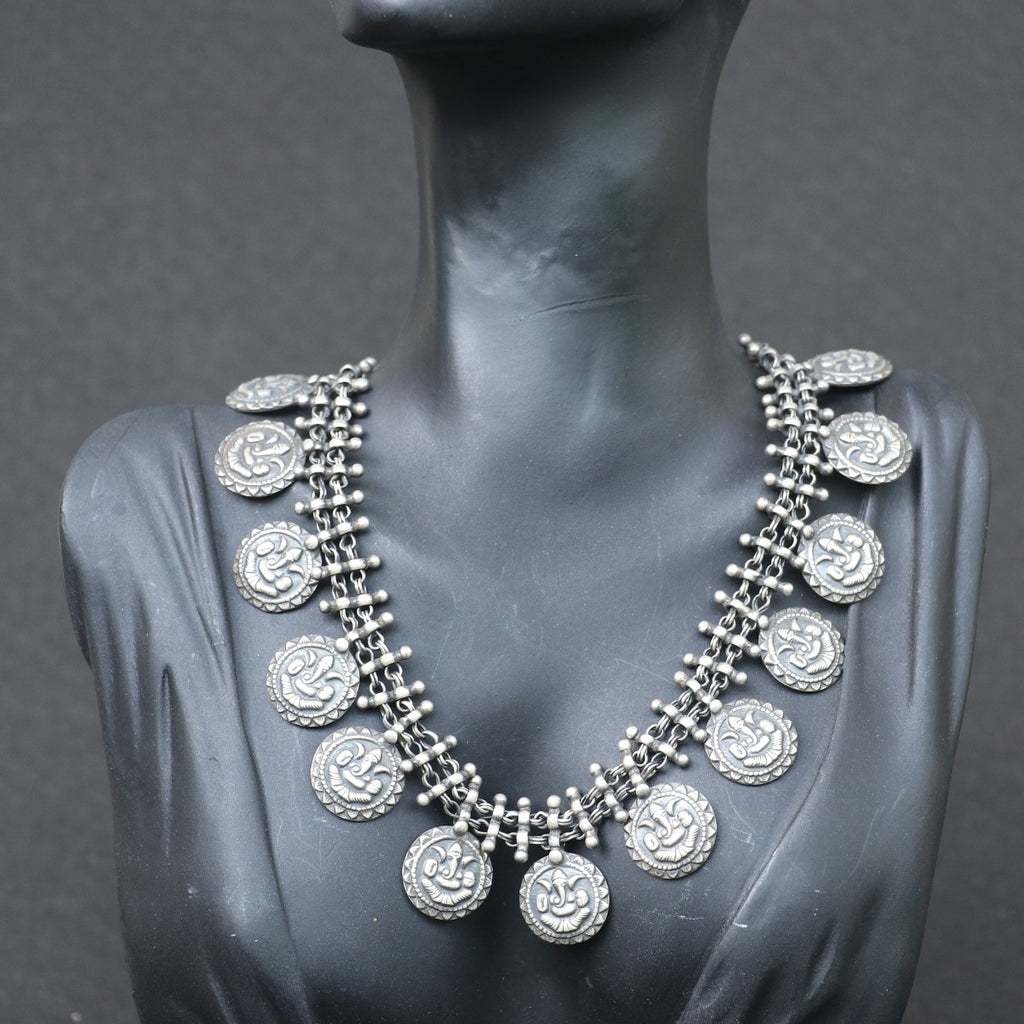 SILVER NECKLACE WITH LAYERED CHAIN DESIGN AND ENGRAVED COIN SHAPE GANESH