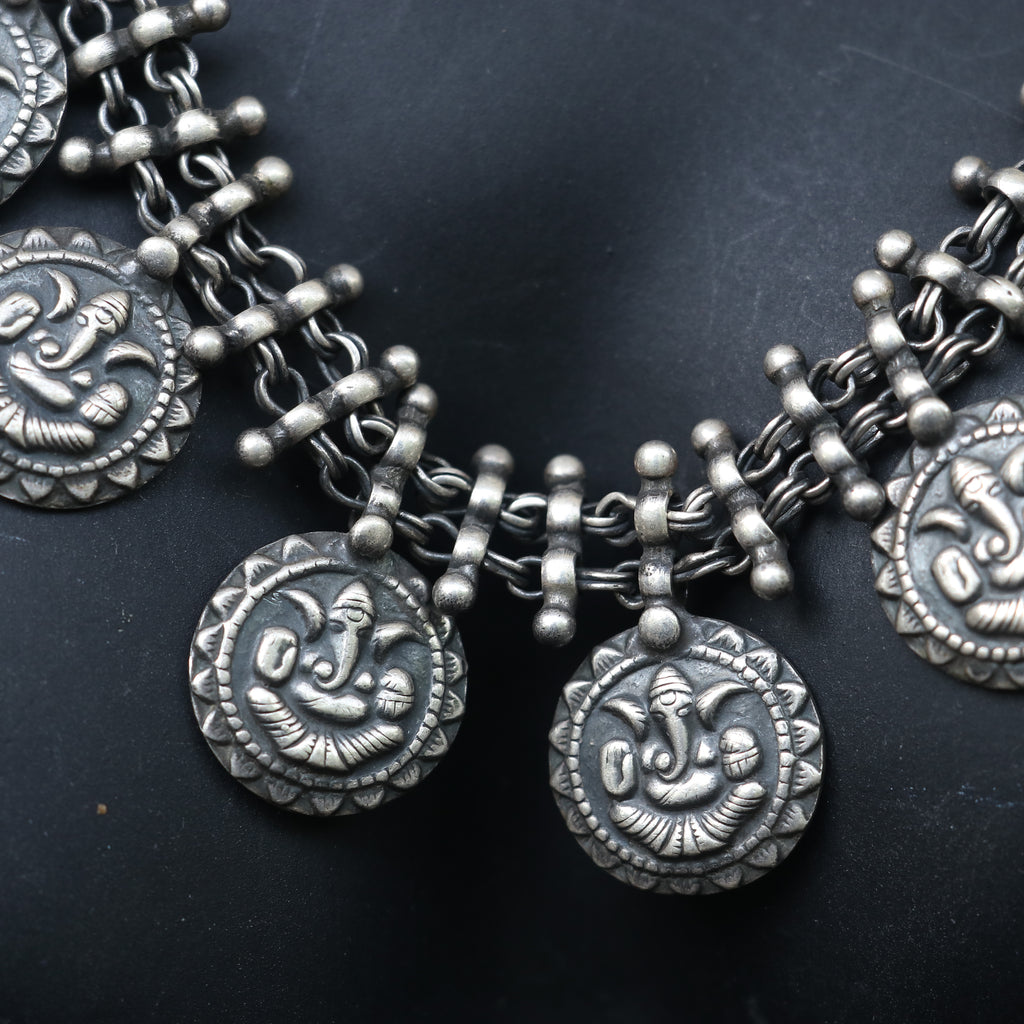 SILVER NECKLACE WITH LAYERED CHAIN DESIGN AND ENGRAVED COIN SHAPE GANESH