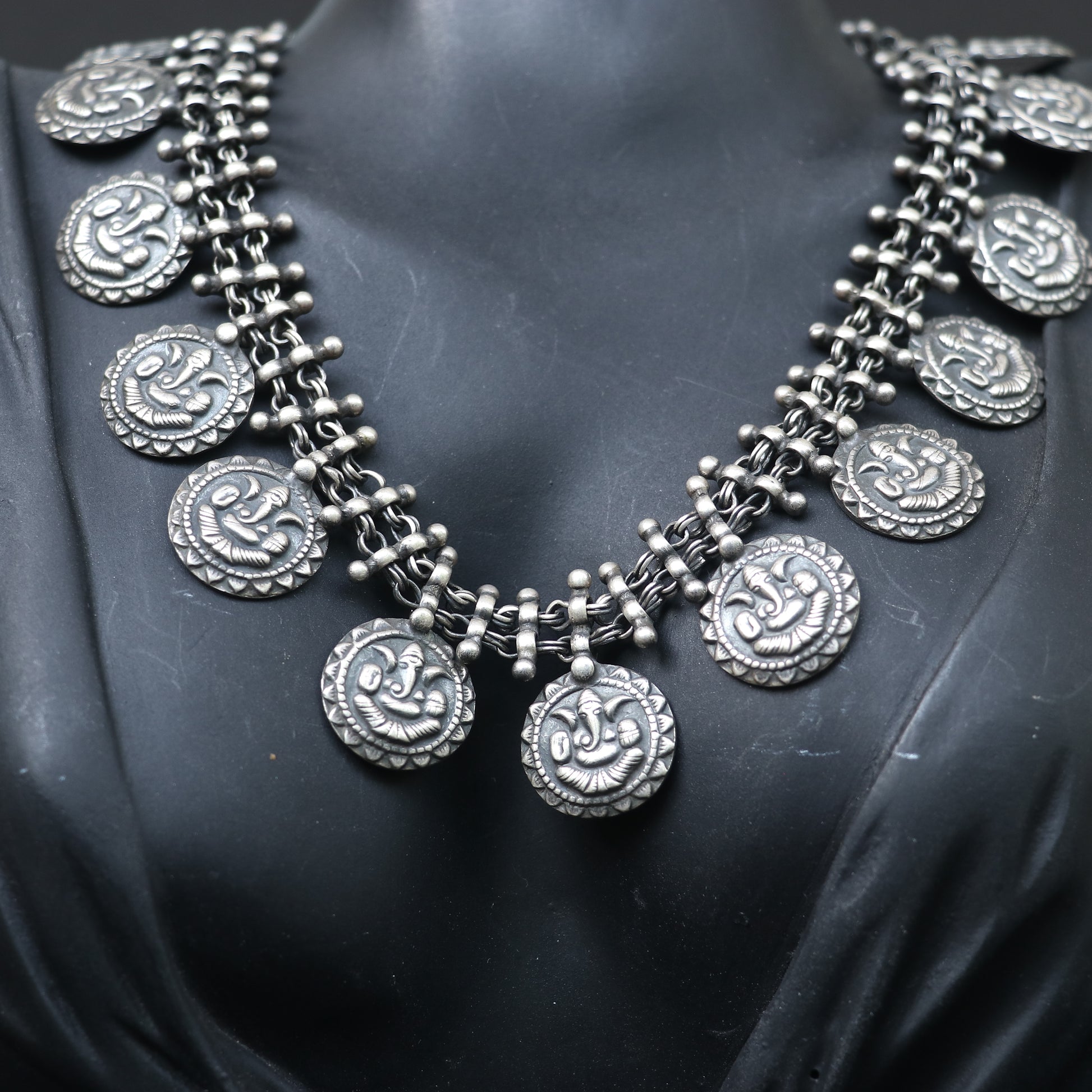 SILVER NECKLACE WITH LAYERED CHAIN DESIGN AND ENGRAVED COIN SHAPE GANESH