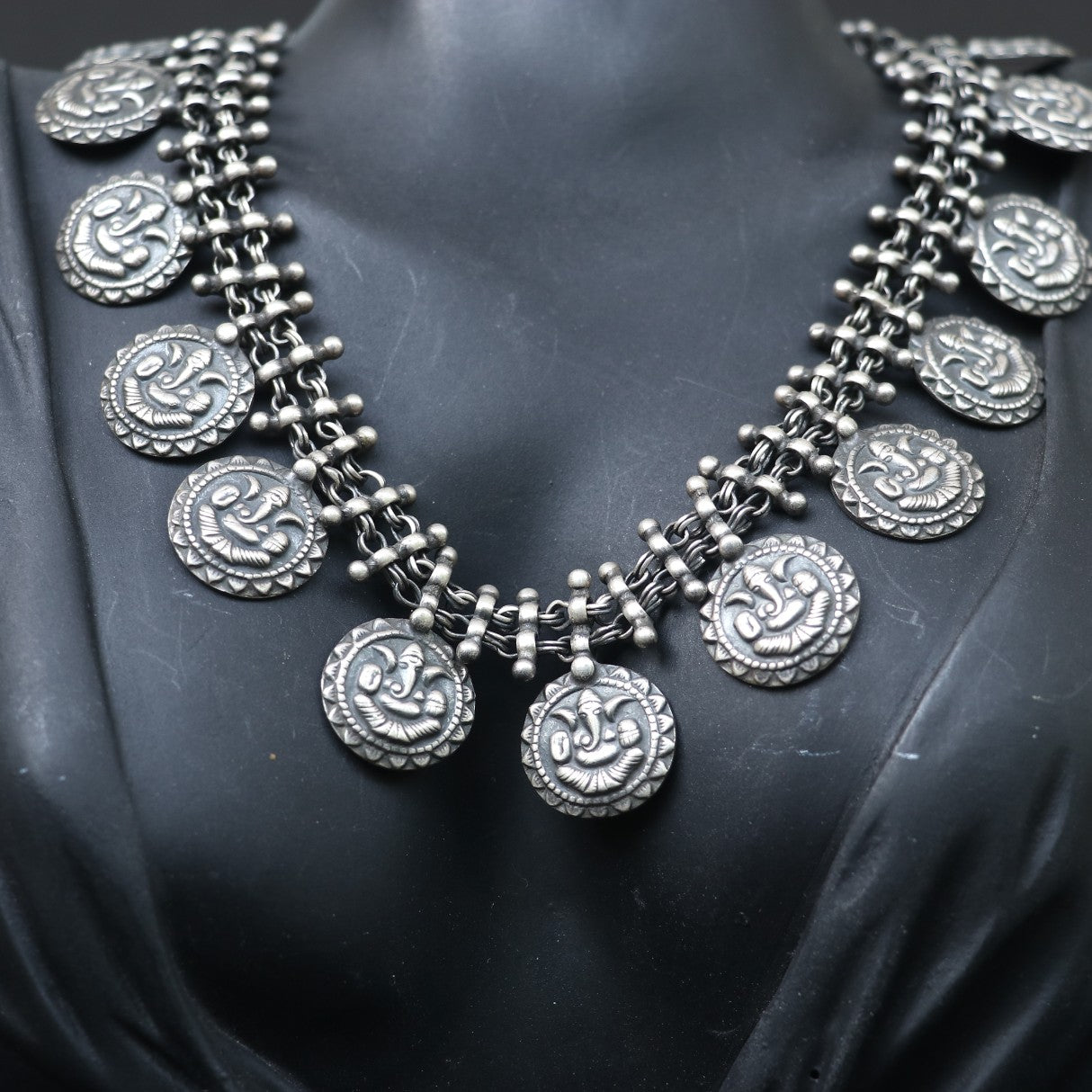 SILVER NECKLACE WITH LAYERED CHAIN DESIGN AND ENGRAVED COIN SHAPE GANESH