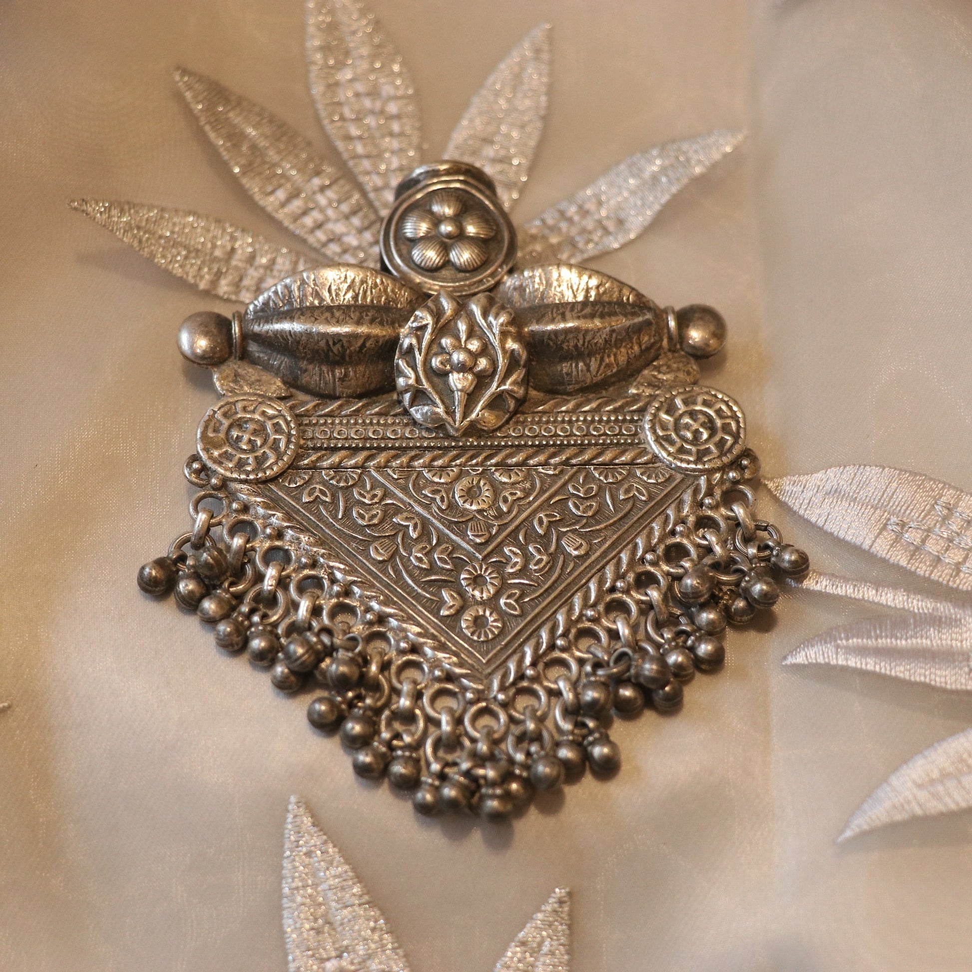 SILVER PENDANT WITH FLORAL CRAVINGS AND HANGING BEADS