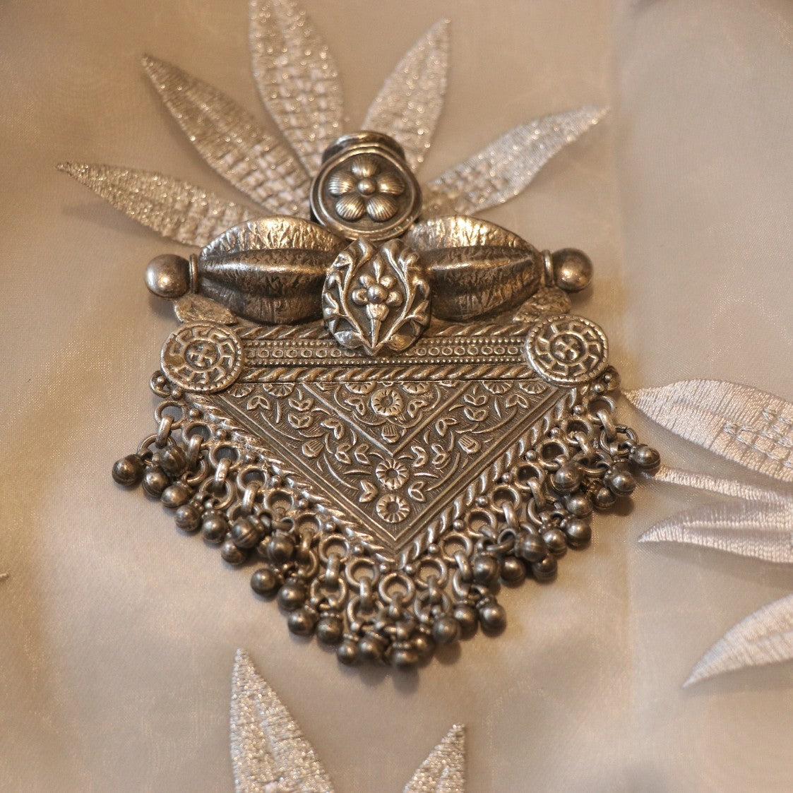 SILVER PENDANT WITH FLORAL CRAVINGS AND HANGING BEADS