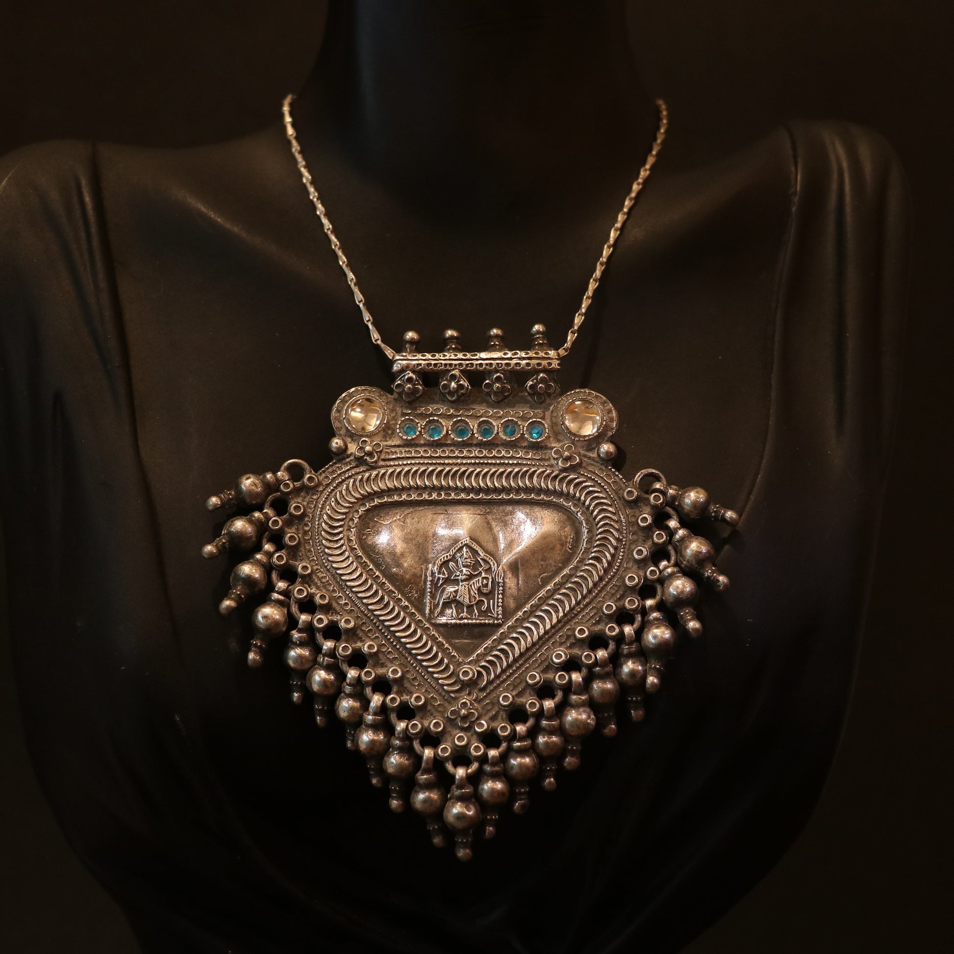 SILVER PENDANT WITH TRIBAL MOTIF , BLUE ACCENTS , AND HANGING BEEDS