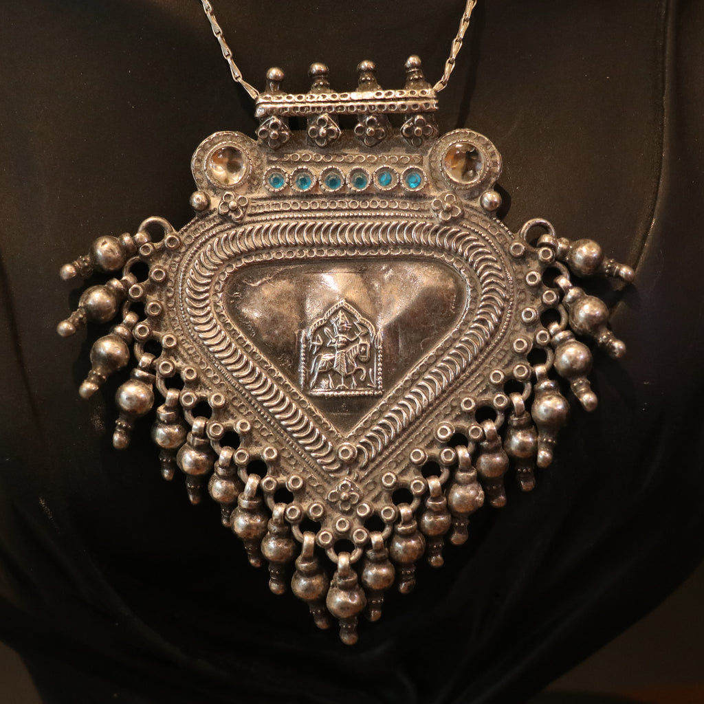 SILVER PENDANT WITH TRIBAL MOTIF , BLUE ACCENTS , AND HANGING BEEDS