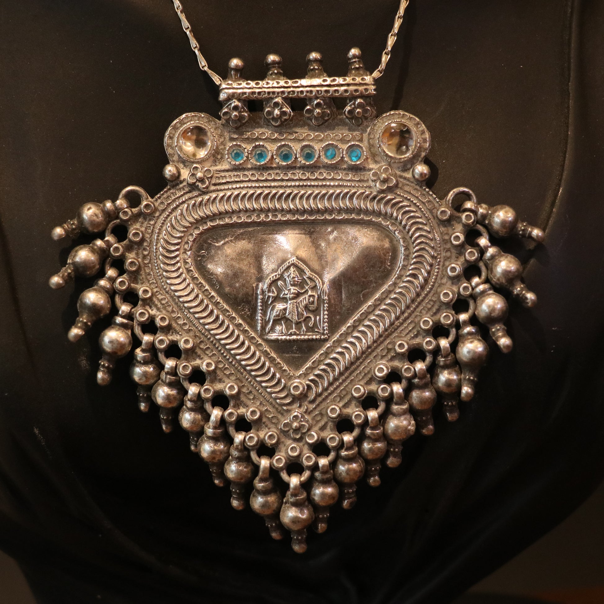 SILVER PENDANT WITH TRIBAL MOTIF , BLUE ACCENTS , AND HANGING BEEDS